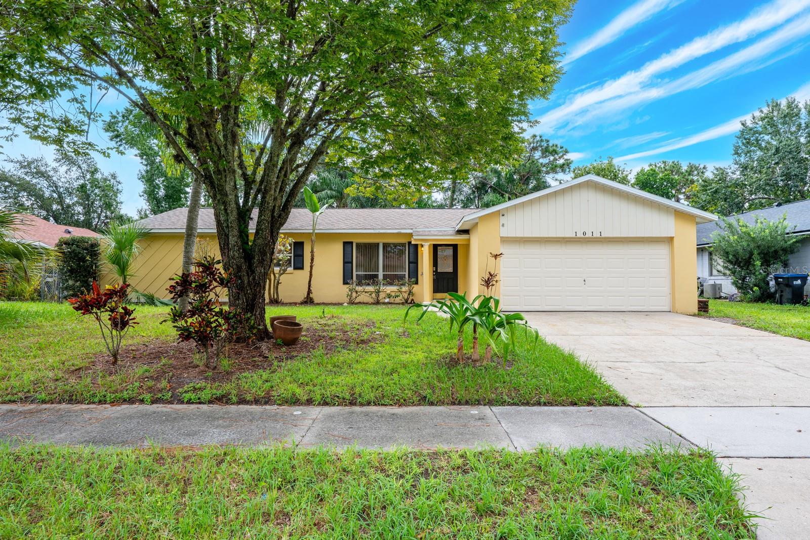 One or more photo(s) has been virtually staged. Ask about a lender provided RATE BUY-DOWN CREDIT on this home! **WELCOME HOME** Set on a spacious .25 ACRE LOT in the established Rio Pines community, this single story BLOCK HOME offers an opportunity for you to move right in and make it your own. With NO HOA restrictions, an A-RATED ELEMENTARY SCHOOL nearby, and easy access to SR 408 – this home combines everyday convenience with the freedom to create the indoor and outdoor space of your dreams. The interior delivers a practical SPLIT BEDROOM layout designed for privacy and functionality. The PRIMARY SUITE occupies one side of the home, while two additional bedrooms are on the opposite side, each with its own WALK-IN CLOSET for plenty of storage. WOOD and TILE flooring extend throughout the living areas and bedrooms, giving the home a low maintenance feel. The kitchen, open to the dining area, creates a central space that works well for daily meals and gatherings. Sliding glass doors fill the room with natural light and lead to a SCREENED LANAI, perfect for enjoying your morning coffee or unwinding in the evenings. From the lanai, step out into the FENCED BACKYARD, a generous space for pets, play, or future projects — framed by mature landscaping that enhances privacy. Practical updates mean you can move in with peace of mind: the roof and A/C were both replaced in 2016. The location is hard to beat with Downtown Orlando just a short drive away, Waterford Lakes Town Center provides endless shopping and dining options, and outdoor recreation is at your fingertips with Rio Pinar Golf Course and a variety of parks nearby. Whether you are searching for a great starter home, downsizing into single level living, or looking for a property you can update with your own style, this Rio Pines home is a smart choice where original character meets everyday convenience. Call today to schedule a tour!