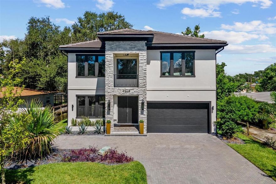 Built in 2022 by renowned local Tampa luxury custom builder, Mobley, and designed by New York designer with Dominican roots, this Timeless Transitional Hurricane Resistant home drips of classic details balanced with sleek, modern touches. It is a gem in the Tampa Bay luxury market with so many outstanding features and over $200K of custom upgrades. It is a home to be experienced.  The entryway, featuring a striking black-and-white hexagon marble floor, sets the tone for the grand staircase landing, illuminated by natural light streaming through custom hurricane-impact casement windows. Tray ceilings and crown molding frame designer light fixtures that elevate the office, living, and dining areas. Every detail has been thoughtfully curated with elegance in mind, while soaring 10-foot ceilings and 8-foot doors enhance the sense of scale and versatility throughout the home.  At the heart of the home, a dramatic combination of Panda Marble and Black Matte Quartz sets the stage for a kitchen designed as both a showpiece and a chef’s haven. The 9x7 oversized island, complete with abundant storage and seating for four, features a purposeful waterfall edge in Panda Marble, beautifully accented by Black Matte Quartz countertops. This striking design extends into a matching backsplash, seamlessly connecting to the paneled refrigerator and a full wall of custom storage—perfect for holiday serveware and kitchen essentials. Additional highlights include a secondary sink, full-house water filtration with reverse osmosis, luxury Jenn-Air appliances such as a built-in espresso machine, 6-burner gas stove with double oven, commercial-grade hood vent, and custom wood cabinetry with pull-out pantry.  The primary suite welcomes you with elegant double doors, expansive his-and-hers closets, parquet wood floors, and a private balcony—an inviting sanctuary of its own. The spa-inspired bathroom offers a walk-in glass enclosed shower with massage jets, rain shower with handheld, oversized niches, and a built-in bench, creating the ideal space to unwind, while the deep soaking acrylic tub offers full-body relaxation. Each bathroom is crafted with floor-to-ceiling porcelain tile showers accented by striking, hand-selected stone slabs. Spa-inspired design meets function with premium fixtures, backed by a lifetime guarantee, blending enduring quality with refined architectural style.  The “Bonus Room” includes 544 SF can be what you dream it to be - theatre room, game room, den…make of it what you’d like. Water line installed, ventilation, and wired for surround sound, the possibilities are endless!  Centrally located near South Tampa’s top restaurants, shopping, coffee shops, and schools—including the coveted Plant High School—this home offers both convenience and prestige. Positioned outside of a flood zone and in a non-evacuation area, it is truly a rare find in one of Tampa’s most sought-after zip codes. Built to most updated hurricane codes: impact windows, concrete block construction on both levels, stem walls, generator hook-up with gas propane tank, and at a higher elevation, you can have peace of mind. Schedule your private showing today.