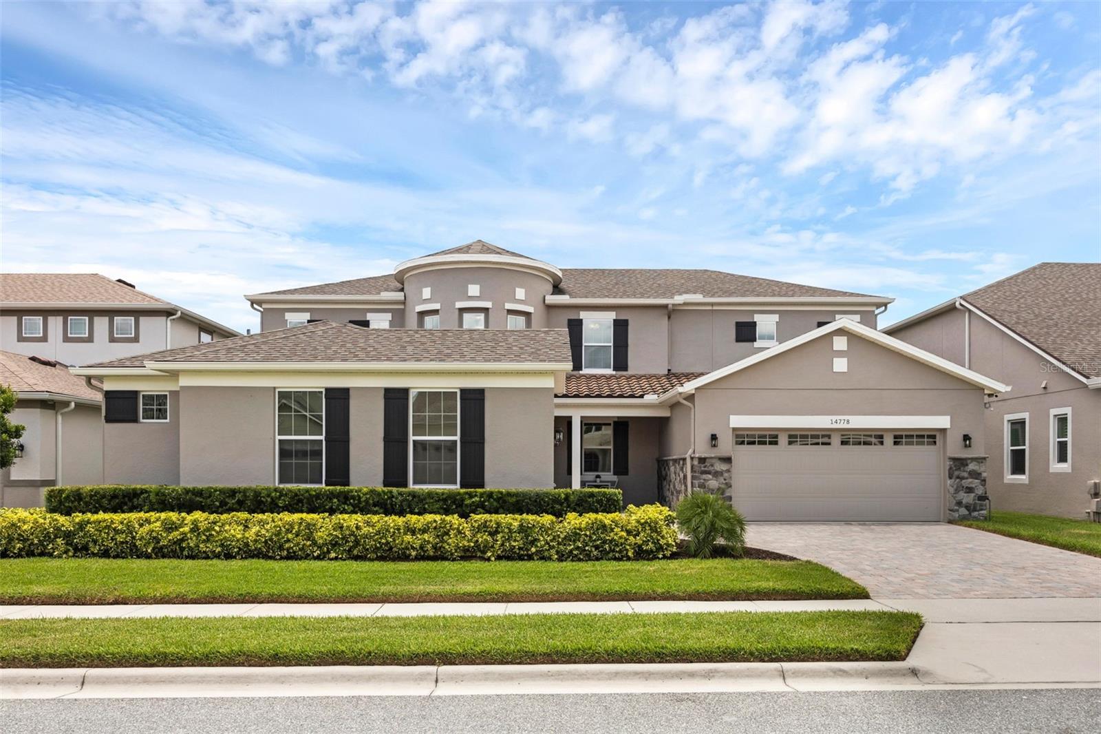 Architecturally Distinctive and Thoughtfully Designed – “The Yorkshire” in the popular Oxford Chase community. From the moment you arrive, this executive-style residence immediately distinguishes itself as one of a kind. Designed with impact and elegance, the entry welcomes you with a charming front patio that creates a natural and inviting transition into the home. Built by Mattamy Homes, the home offers nearly 4,700 square feet of expertly crafted living space, featuring 6 bedrooms, 4.5 baths, and an exceptional layout that blends openness with purpose. At the heart of the home is a grand rotunda foyer - a striking architectural centerpiece that seamlessly connects multiple spaces and sets the tone for the home’s refined, yet functional, design. The two-story family room impresses with magnificent ceilings and natural light, while the spacious kitchen was designed to be the true gathering place - anchored by an oversized quartz island with seating and storage, and equipped with a natural gas cooktop, double ovens, and stainless-steel appliances. A mix of white and soft gray cabinetry provides a timeless, modern aesthetic. Adjacent to the kitchen, a built-in desk nook is perfect for remote work or organization, and the spacious mudroom leads to an oversized laundry room with extensive cabinetry, deep sink, and folding counter. The first floor includes a formal dining room and a bedroom with double-doors - ideal for a home office or playroom. A private downstairs guest suite includes its own ensuite bath and walk-in closet. The primary suite, also on the main level, features dual walk-in closets, a garden tub, and a large walk-in shower for a spa-like retreat. Upstairs, a massive bonus room offers versatile space for games, media, or relaxation – plus the dedicated media room, accessed through double doors and featuring a charming rotunda alcove, is perfect for a home theater, reading lounge, or additional office space. Three more bedrooms are located on the second floor, including a private suite and two connected by a jack-and-jill bathroom. Step outside to a serene and private backyard oasis, complete with a screened saltwater pool, fire pit, and no rear neighbors - an ideal setting for entertaining or unwinding with the family. Additional features include a split 3-car garage with a generator bypass, offering generous space for storage, hobbies, or recreational gear, along with a freshly painted interior for a move-in-ready feel. Conveniently located in the gated community of Oxford Chase, residents enjoy natural gas, low HOA fees, walking trails, a dog park, and playground - elementary school and middle school kids can walk to top-rated schools (located just outside the gate) and just minutes from Winter Garden Village shopping, major highways and the charm of downtown Winter Garden. Move-in ready. Schedule your private tour today - this truly one-of-a-kind home won’t last long.