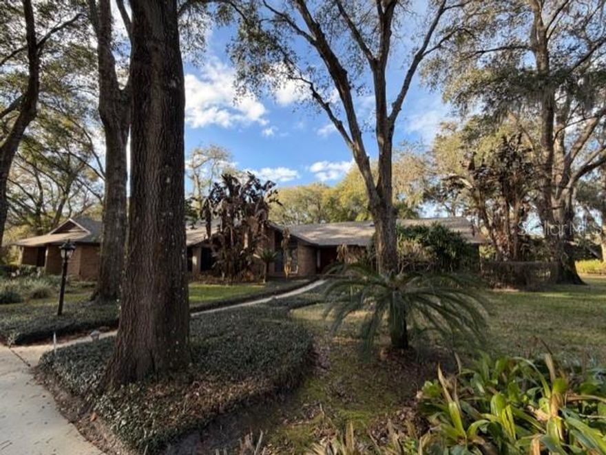 This is a one-of-a-kind serene, beautifully landscaped property in a gated community situated off Markham Woods Road in the exclusive Longwood-Lake Mary area. The community is comprised of only eight residents with each having 1 to 3 acres enjoying much privacy. Owned by the original owners, custom built with many upgrades. This home is immaculate, no pets or kids over the years, and very diligently maintained. There is a new roof (installed within the last two years.) There is a whole house generator. The property is next to the community tennis court, that has two parking spaces. The photos shown do not portray what incredible landscaping is here, because of the recent freeze. Many details such as built in medicine cabinets to 5 skylights, etc. The 2nd bedroom is an office with beautiful built-in bookshelves with sweeping wrap windows. Security system is hardwired and very sophisticated. Garage is 34x24 can be considered as a 3 car garage. There is also a free standing building called the "boathouse" that could house a trailer with boat, concrete floor with electric. The pool porch has 2 fans.