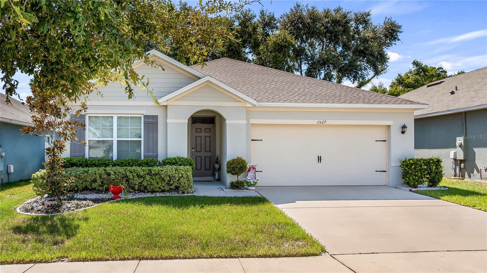 This stunning one-owner home showcases exceptional pride of ownership throughout, featuring a new architectural shingle roof and immaculate landscaping that creates beautiful curb appeal. The thoughtfully designed open floor plan seamlessly connects the kitchen and family room, creating an ideal space for daily living and entertaining, while the separate dining room offers lovely rear yard views. The well-appointed kitchen serves as the heart of the home with its convenient island and breakfast bar, ideal for casual meals and gathering with family and friends. The practical split bedroom layout provides excellent privacy, with the spacious primary suite featuring a generous walk-in closet and an elegant bath complete with dual vanities and a sleek glass-enclosed shower. Additional conveniences include an inside laundry room and an attached two-car garage for year-round comfort and storage. Go outside to the covered rear porch, an inviting space that overlooks the privacy-fenced backyard, creating your personal retreat. The location offers a blend of tranquil living and convenient access to downtown Groveland, less than a mile away, providing easy access to restaurants, services and charming local shops. Daily necessities are just three miles away at the Publix shopping center, and Lake David Park offers wonderful holiday celebrations and community activities throughout the year. This immaculate home represents an exceptional opportunity to own a move-in ready property in a desirable and well-connected neighborhood.
