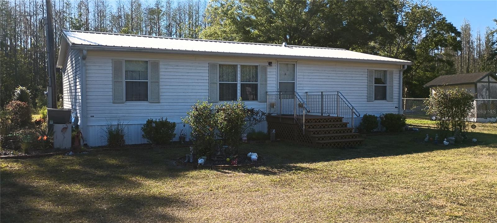 Great opportunity to live in the country no CDD or HOA!! Home features 3 bedroom 2 bath with a large master bedroom, walk-in closet and remodeled bathroom. Kitchen and living room are spacious, plumbing has been updated and metal roof replaced. Central A/C is 2 years old. There are two sheds one 12 by 24 and 10 by 17. Troy-built lawn mower purchased three years ago will also stay. The property is fenced in the front and along the sides except the back which leads to a canal. Seller will also leave the chicken coop with 8 hens
that are laying eggs. The yard is very big and perfect to build a pool or just relax with the family. Buyer to check public records for accurate property measurements.