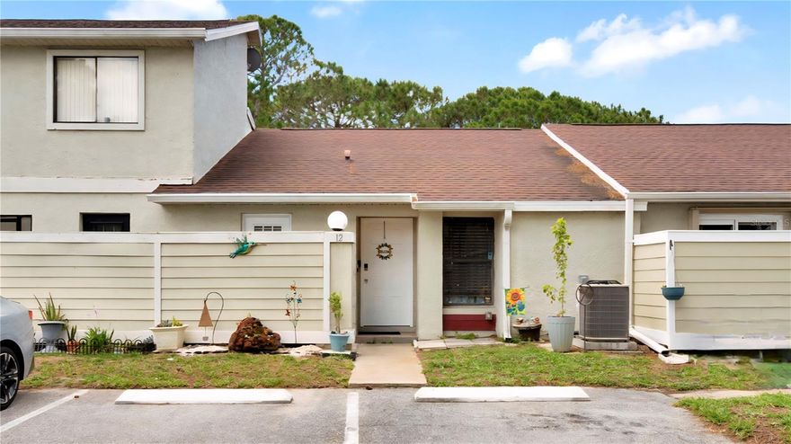 Cared for by the current owner for the past 11 years, this lovely villa-style townhome is move-in ready! TOUR THE HOUSE WITH THE VIRTUAL TOUR and WALK THRU VIDEO LINKS. Step inside to discover high ceilings, natural light, and tile flooring throughout the house (no carpet). The layout of the house makes it feel larger than you would expect. A split floorplan provides one bedroom at the front of the house and a full bath, and the primary at the rear of the house. A spacious great room will become your place for relaxing and entertaining, with ample room for your living room furniture as well as a dining room table. The family cook will appreciate the elegant granite countertops and Shaker-style wood cabinets with soft-close doors, as well as the open pass-through to the great room. Step out the sliding glass door to the screened patio to enjoy your morning coffee, or unwind at the end of the day. You’ll also find a storage closet off to the side of the patio. Retreat to the spacious primary suite and delight in the custom walk-in closet, large vanity, and private toilet and tiled shower. The house has a new A/C (2022), fresh paint, and the roof is less than 10 years old. Residents of Pine Island Villas enjoy a care-free lifestyle with exterior landscaping and maintenance included with the reasonable $150/month HOA fee, giving you more time to visit with friendly neighbors at the sparkling pool and cabana just steps away. Plus, the location can’t be beat---with nearby shopping, groceries, restaurants, banks, gym, and public transportation options. Just 30 minutes from the world class theme parks, airport, and downtown Orlando!