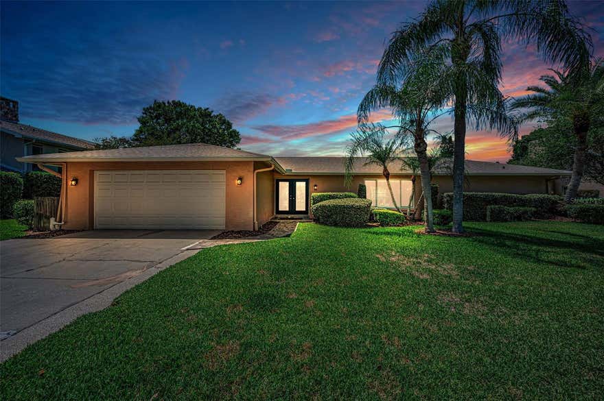 One or more photo(s) has been virtually staged. Move-in Ready and BEAUTIFULLY UPDATED, this inviting One-Story home in the Gated, Golf Community of EAST LAKE WOODLANDS offers 3 Bedrooms, 2 Baths and a spacious Outdoor Living Area. Step inside from the Double Glass Door entry to LUXURY VINYL PLANK FLOORING and TILE THROUGHOUT with No Carpet, loads of Natural Light, an Updated Kitchen with Wood Cabinetry and lots of storage and Full Pantry plus Fully Renovated Bathrooms. An Open Concept defines the combined Living and Dining Rooms with the added bonus of a Family Room open to the Well-Equipped Kitchen with Bar Seating. The Primary Bedroom is a true retreat with a Gorgeous Bath with STUNNING TILE, Spacious Vanity with QUARTZ COUNTERTOPS and Generously-Sized Closet with plenty of Built-ins. The Second and Third Bedrooms feature Vinyl Plank Flooring and have access to the Updated Guest Bath with a Soothing Color Palette, Vanity with QUARTZ COUNTERTOPS, Accent Lighting and Beautiful Tile. French Doors open to a SPARKLING POOL and oversized Covered Lanai, creating the perfect setting for relaxing or entertaining. The generous yard adds privacy and room to enjoy the outdoors. Additional Highlights and Upgrades include HURRICANE IMPACT WINDOWS, SHINGLE AND FLAT ROOFS REPLACED IN DECEMBER 2024, NEW WATER HEATER IN 2025, NEW DISPOSAL IN 2026, FRESH INTERIOR PAINT IN MAY 2026 - so you can just move in and relax! All this in a location convenient to Tampa International Airport, Beaches and Parks, Medical Facilities, Professional Sporting Events, Dining and more. Plus with optional memberships to Ardea Country Club, enjoy access to 2 Golf Courses, a Fitness Center, Tennis and Pickleball as well as a Heated Lap Pool and Freeform Pool, Poolside Café, Casual and Fine Dining and Events.