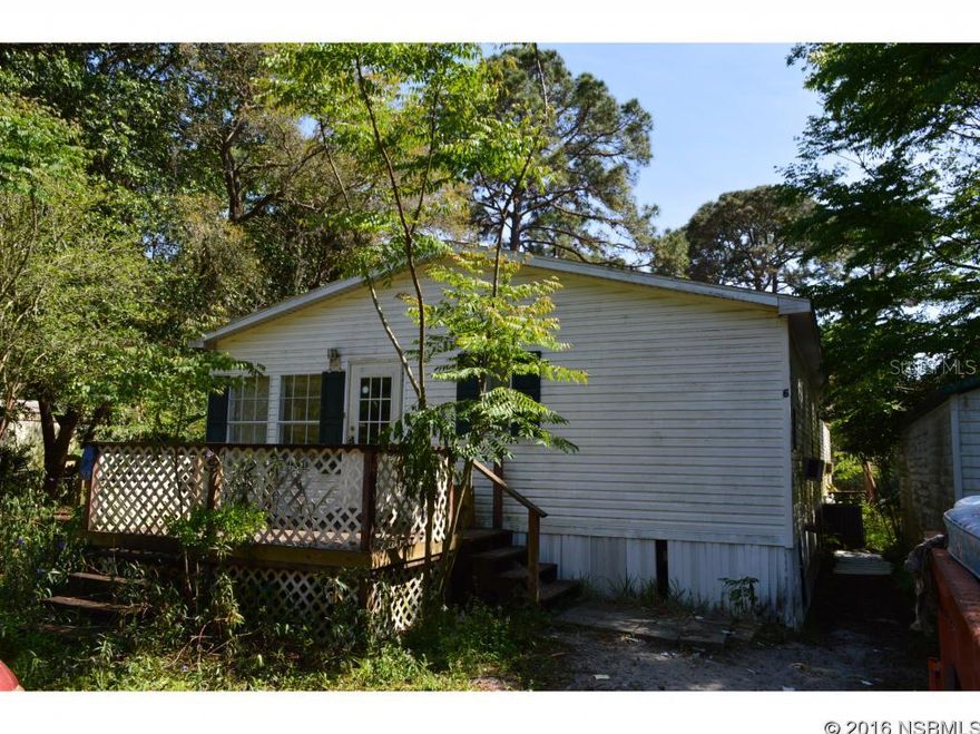 This is property tucked away in a small MH community just off Spruce Creek Road S of Taylor Rd. In need of renovation, it could be brought back to life w some creativity and elbow grease. The large sq footage would provide for a nice home on a large lot for couple or large family. There are 2 out bldgs., one about the size of a one car garage, the other a large storage unit. This is not a project for the weak at heart. This property sold AS IS with no warranties implied. Cash offers only as this home will not pass any home inspections. ;Water: City