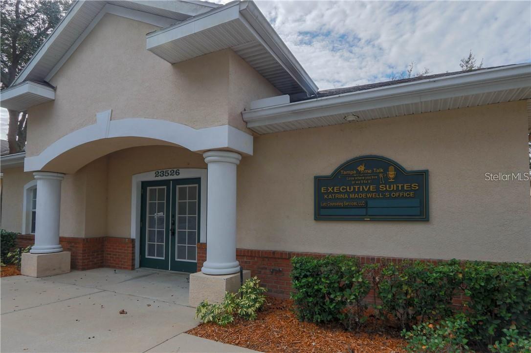 If you're looking to elevate your business without the commitment of a traditional commercial lease, this executive office suite on SR 54 might be exactly what you need. BY APPOINTMENT ONLY. Located at the highly visible intersection of State Road 54 and Livingston, this space offers convenience, professionalism, and flexibility—all in one of Pasco’s most central business hubs. We currently have two private offices available for lease, each approximately 80 square feet (more or less), ideal for a solo professional or small business setup. Offices are move-in ready and can be leased either unfurnished or with one desk and three chairs, depending on your needs.
This is a shared office environment, offering full access to thoughtfully designed common areas, including a stylish lobby, a fully furnished conference room, two restrooms, a shared workstation, and a modern kitchen. Rent includes all utilities—electric, water, sewer, trash—plus weekly cleaning of common areas, a keyless entry system, and a security system for peace of mind. High-speed internet is available, and perhaps best of all, a professional staff member is onsite to greet your clients and visitors during regular business hours.
The location is unbeatable—just minutes from I-75, Tampa Premium Outlets, and plenty of restaurants and retail options. Whether you’re meeting with clients or simply want an easy commute from anywhere in the Bay area, this office space offers both practicality and prestige. These offices rarely stay available for long, so don’t miss your chance to set your business up in a space that reflects your success. Photos are older and offices/main areas are more updated. NEW photos coming soon!