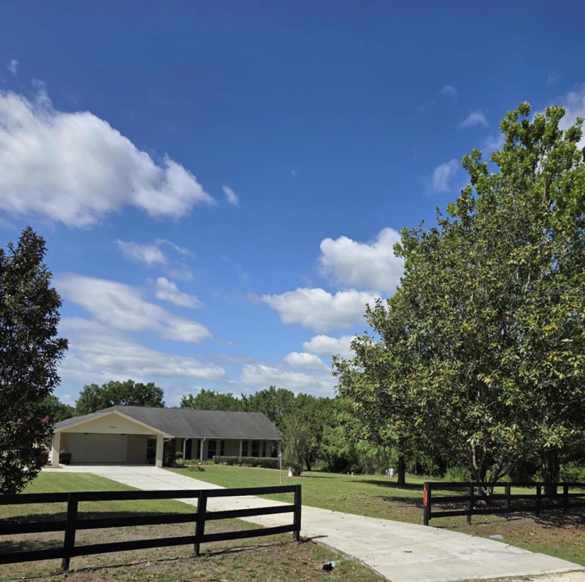 Nestled in the rolling hills of Ocala's horse country this 3.42 acre property is located at the end of a quiet country lane and lends itself to a
ranching, farming or recreational lifestyle. This spacious 3360 square feet, 3 bedroom 2 bath split floor plan boasts a vaulted grand living area with
large dining room, living room, family room and eat in luxury kitchen complete with large cooktop island. A large solar heated screened in pool
compliments a roomy outdoor living area including an outdoor shower. The over sized master bedroom is complimented by a large walk in closet,
custom built in vanity area and an oversized soaking tub. As you are soaking enjoy the views through the picture window of a stone water fall and
koi pond. Custom cabinetry throughout the house increases the versatility of each area but no more than seen in the laundry room and oversized
two car garage. Connected to the garage is a fully roofed elongated carport with full walk up attic storage. An additional bonus to this property is
its adjacent but separate 2bd/2bth 1000 sq ft manufactured home perfect for guest cottage or rental unit. The house is equipped with a whole
house generator.
Land, Site, and Tax Information
Legal Desc: tract number 1, block (D), Broadmeadows, as recorded in platt book R, pages 21-23 public records of Marion county fl
SE/TP/RG: 34-16-22