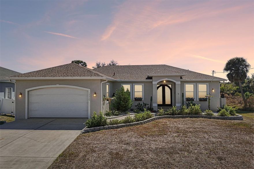 Discover the essence of true Florida waterfront living with this stunning three bedroom, three bath pool home perfectly situated on the Ingersol Waterway with just one bridge to the Myakka River and direct access to Charlotte Harbor, Boca Grande and the Gulf of Mexico. This residence blends timeless design with modern comforts, offering the perfect setting for those who appreciate privacy, craftsmanship, and the coastal lifestyle. From the moment you arrive, the custom handcrafted iron front door makes a statement with its intricate design and vertical deadbolts, that immediately conveys elegance. High vaulted ceilings and custom wainscoting combine with porcelain tile flooring throughout and designer lighting to create a bright and welcoming atmosphere. Expansive windows draw your attention to the beautiful saltwater canal framed by lush tropical landscaping.
The chef’s kitchen is a true masterpiece of design and functionality, thoughtfully crafted for both everyday living and elegant entertaining. Beautiful Café brand appliances complement the custom-built cabinetry, which showcases exceptional craftsmanship and convenient design details, including a built-in coffee bar area, soft interior lighting, and subtle under-island illumination that enhances the ambiance. Every cabinet has been carefully designed with purposeful touches that maximize storage and style. The centerpiece of the kitchen is a striking imported Acacia wood island, perfectly paired with exotic Ocean Wave granite countertops. A stunning Mother of Pearl marble backsplash extends behind the custom range hood, transforming the cooking area into a work of art and creating a seamless blend of warmth, sophistication, and visual appeal.
The spacious primary suite provides a peaceful retreat with high tray ceilings and an elegant ensuite bath featuring two vanities, a walk-in shower, and a luxurious garden tub. Dual walk-in closets with custom shelving provides generous storage while maintaining a refined appearance. The two additional bedrooms are equally inviting, and the second bathroom conveniently serves as a pool bath.
Access the lanai and pool area to experience the very best of Florida outdoor living. The expansive screened lanai features custom lighting, a sparkling pool, and a new electric roll-down storm shutter for added protection. It is the perfect space for entertaining or simply unwinding in the gentle coastal breeze. The property extends to a sturdy IPE wood dock complete with solar lighting and a ladder, ideal for kayaking, fishing, or launching a boat for a day on the water.
Extensive updates enhance peace of mind, including a new roof completed in January 2025, a new pool pump in 2024, a whole-home reverse osmosis system, and Generator Inlet to power your home if needed.
With no deed restrictions, this property provides the freedom to bring your boat, RV, or other recreational vehicles. Whether you are seeking a peaceful retreat, a home designed for entertaining, or a base for exploring Southwest Florida’s incredible waterways, this property delivers.
The adjacent lot is also available for purchase, offering an excellent opportunity to expand your space, add a workshop, garage, or guest suite, or simply enjoy additional privacy and open green space.
Every detail of this residence reflects thoughtful design, fine craftsmanship, and pride of ownership. Schedule your private showing and see why this exceptional home stands out as a true Gulf Coast gem.