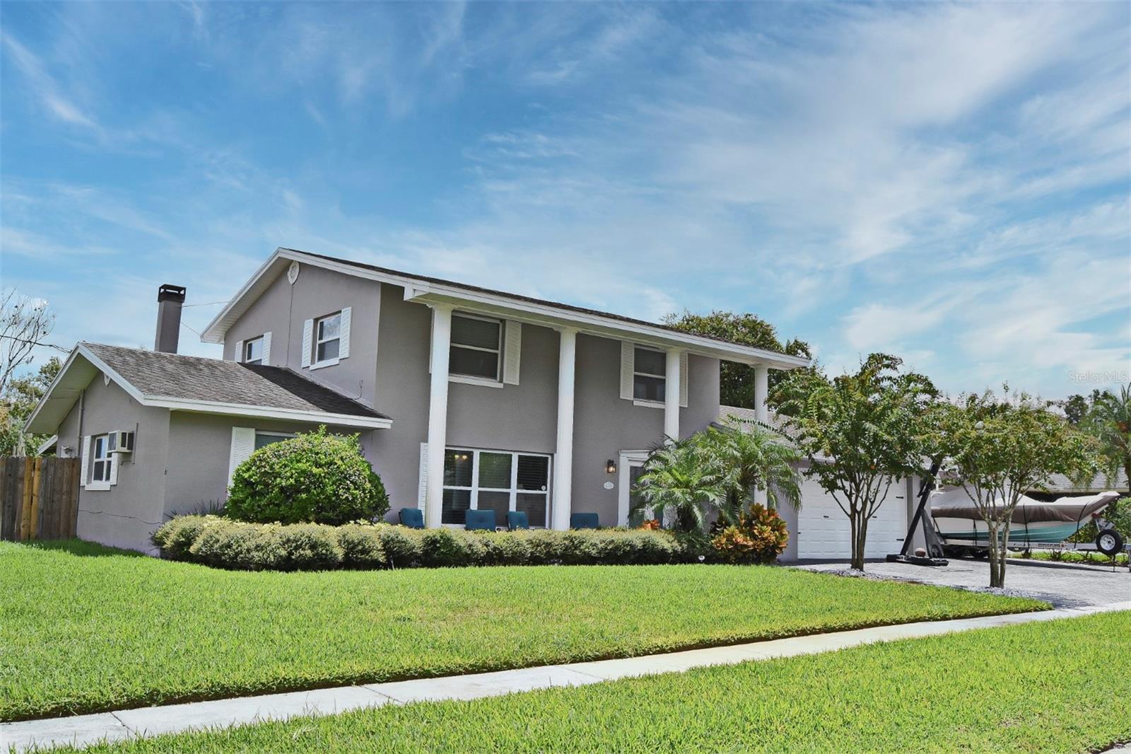 Have you heard? This beautiful two story, five-bedroom, three-bathroom, POOL home is waiting for you. Enjoy some space between you and your neighbors as this home is nestled on over a quarter of acre (.29). The welcoming curb appeals leads you up to the two-story front porch highlighted with large columns. Upon entering, you are greeted by modern luxury plank flooring that seamlessly flows throughout the main living area. The decorative chair rails and molding enhance the design, providing an elegant touch. Whether you wish to relax in the spacious living room or host an unforgettable game night, this space is ideal. Prepare your favorite meals in the kitchen, which is equipped with stainless steel appliances, smooth granite countertops, shaker-style cabinetry, and a decorative backsplash. The adjoining dining room makes entertaining a breeze. On the first floor, you will find two bedrooms, one of which features its own wood-burning fireplace, creating a cozy atmosphere. Retreat to the primary bedroom located on the second floor, which includes an ensuite bathroom with dual vanities and a shower. Additionally, the second floor offers two ample sized bedrooms and a full bathroom. Let’s step outside to your very own backyard oasis! Relax in the covered, screened-in patio or take a dip in the large, deep, sparkling blue pool while enjoying views of the expansive yard. The storage shed, built in 2018, provides ample space for your pool or yard essentials. The yard is enclosed by a privacy fence and features gates on each side for easy access. Don’t forget the two-car garage, which offers ample parking and storage, along with an additional parking pad on the side—perfect for large vehicles, recreational vehicles, or boats. The stamped concrete driveway was completed this year and adds a great touch to the curb appeal. Best of all, there is no HOA! This home is located within the Idyllwilde of Loch Arbor community, conveniently near a variety of shopping, dining, and entertainment options. With easy access to I-4, 417, and 429, commuting is a breeze. Take advantage of the numerous community events hosted by nearby Downtown Sanford and Downtown Lake Mary. Don’t let this opportunity pass you by; call today!