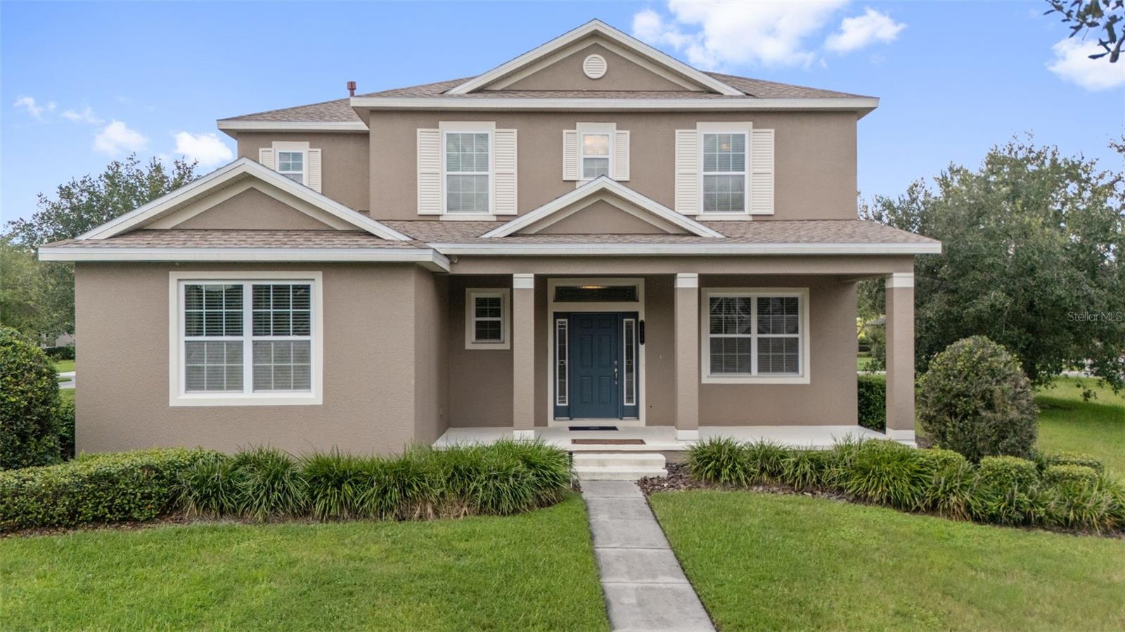 One or more photo(s) has been virtually staged. NOT IN A FLOOD ZONE | NEW ROOF 2025 | BOTH A/C UNITS REPLACED 2025 | FULL INTERIOR REPAINT. Welcome to a rare opportunity to own a one-owner, custom-designed residence in the exclusive, guard-gated enclave of Grand Hampton—one of Tampa Bay’s most sought-after master-planned communities. Tucked away on a quiet, tree-lined street, this expansive two-story home offers timeless curb appeal, lush landscaping, and a welcoming front porch that sets the tone for the elegance inside. Step through the front door and into a grand foyer where 9.5-foot ceilings, natural light, and easy-to-maintain tile flooring create an immediate sense of sophistication. To your right, French doors open into a sun-drenched private office, ideal for working from home in style and comfort. To the left, you’ll find a convenient half bath and a massive walk-in storage closet—perfect for keeping everyday essentials tucked away. Just beyond, the generously sized primary suite serves as a serene retreat, complete with his-and-her walk-in closets and a luxurious en suite bath featuring dual vanities, granite countertops, maple cabinetry, a soaking tub, and a glass-enclosed shower. Continue your tour into the formal dining room—perfect for intimate dinners or festive holiday gatherings—before arriving at the heart of the home: the fully renovated gourmet kitchen. A true showpiece, this culinary space has been completely reimagined with brand-new white soft-close cabinetry, sleek quartz countertops, a designer tile backsplash, and an oversized island that anchors the space with elegance and function. High-end stainless steel appliances, a 5-burner gas cooktop, and multiple sets of 42" upper cabinets offer both beauty and practicality. Every detail has been thoughtfully curated to elevate the cooking experience, while the open-concept design effortlessly flows into the expansive family room and sunlit dinette—creating the perfect environment for entertaining or everyday living. Upstairs, discover four generously sized bedrooms, each offering ample closet space and access to two well-appointed full baths—one a Jack-and-Jill design, the other conveniently located just across the hall. Two additional bonus rooms provide endless flexibility for a media room, home gym, secondary office, or playroom—tailor these spaces to fit your lifestyle. Outside, enjoy Florida living at its finest on the covered lanai, a peaceful spot to relax or entertain while surrounded by the lush, mature landscape unique to Grand Hampton. Notable Upgrades Include: New carpet throughout, Tankless water heater, Enhanced insulation, including a radiant barrier in the attic and additional wall insulation for energy efficiency, full interior repaint, and 3-car garage for ample storage including overhead racks. The community provides a wealth of amenities, including a 24-hour manned gate, state-of-the-art clubhouse, fitness center, playgrounds, lake access, and heated pools—including a lagoon-style pool with slide and a lap pool. Additional recreational features include tennis courts and basketball courts. Conveniently located near major highways I-75 and I-275, this property is just a short drive to local attractions such as Advent Hospital, PHSC, AdventHealth Center Ice, The Shops at Wiregrass, and Tampa Premium Outlets. Don’t miss your chance to own this exceptional home. Schedule your private showing today! For a virtual tour, click the provided link and experience the beauty of this remarkable property.