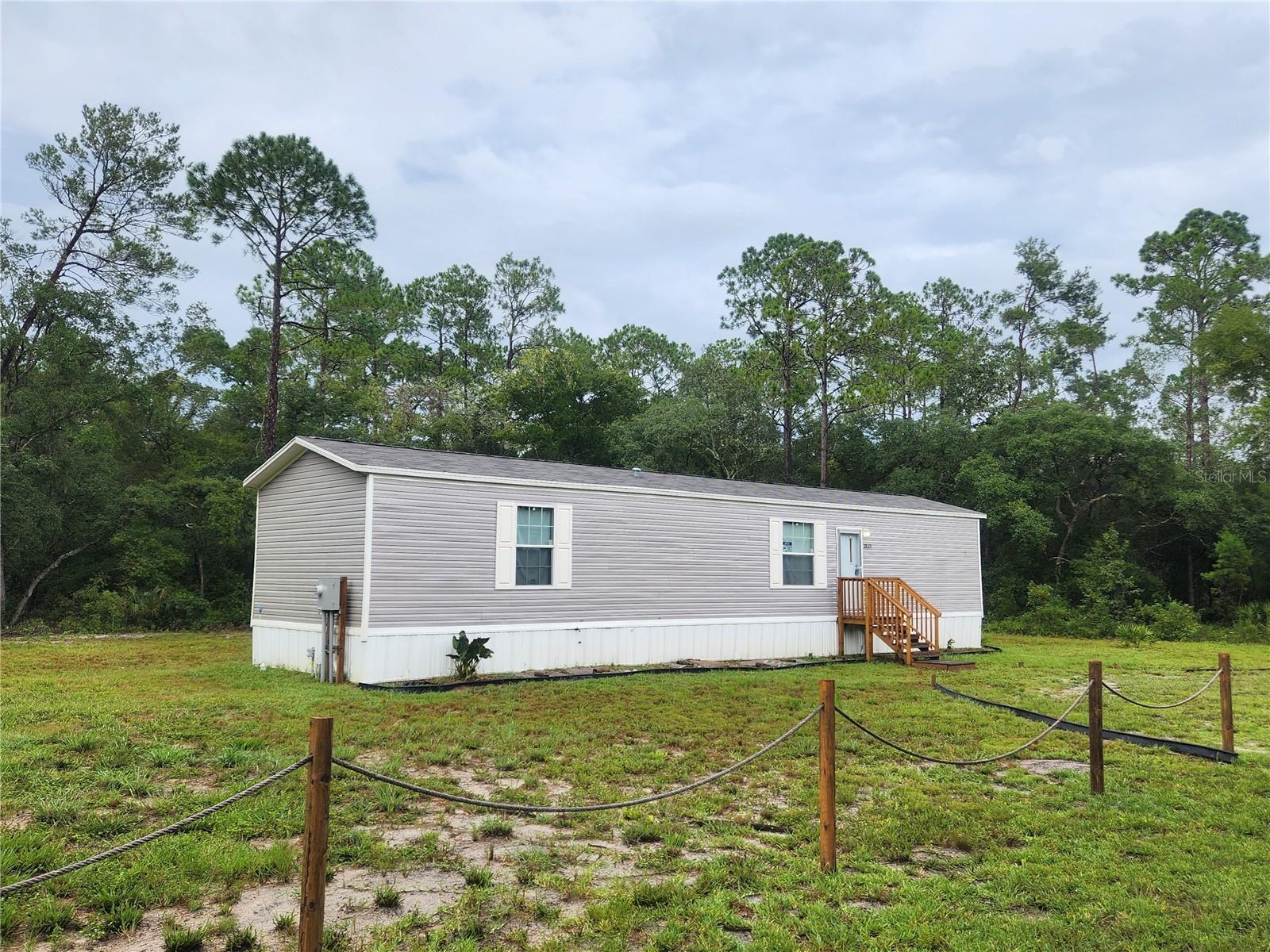 Modern, clean, move-in ready home on almost half an acre. No carpet. No immediate neighbors. Full Financing and Owner Financing available. Two short blocks off a paved road. Like new 2 bedroom, 2 bathroom home offers peace and privacy - this is Central Florida at its best. The neighborhood is mostly wooded and features multiple lakes, including Horseshoe Lake Park. Enjoy the Oklawaha or various activities in the Ocala National Forest or take a drive to Palatka for fishing and shopping, Salt Springs for Lake Kerr and restaurants, Orange Lake for Bass and recreation, or Ocala & Gainesville for everything civilized you might require. Nature abounds in this neighborhood - come, pause, take a deep breath, and listen to the quiet. You may never want to leave.