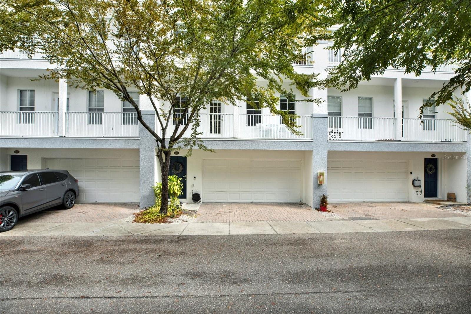 This lovely GATED 3 bedroom 3.5 bath townhome can be yours! Walk in to a first floor that includes a private bedroom with a full bath and access to a two-car garage, perfect for guests or a home office.
The open-concept second floor connects the kitchen, dining, and living spaces with ease. Granite counters, stainless appliances, abundant cabinetry, and a closet pantry add both style and function, while a private balcony expands the living area outdoors. The top floor offers two spacious bedrooms with en-suite baths, including a primary suite with its own balcony and excellent closet space. A full-size laundry area is also conveniently located on this level.
Legacy Park residents enjoy a pool, spa, clubhouse, gated dog park, and oak-lined streets, with HOA fees covering exterior maintenance, water, sewer, and trash. Ideally situated between downtown Tampa and downtown St. Pete, this home places you minutes from Bayshore Boulevard, Hyde Park, local marinas, and the airport.