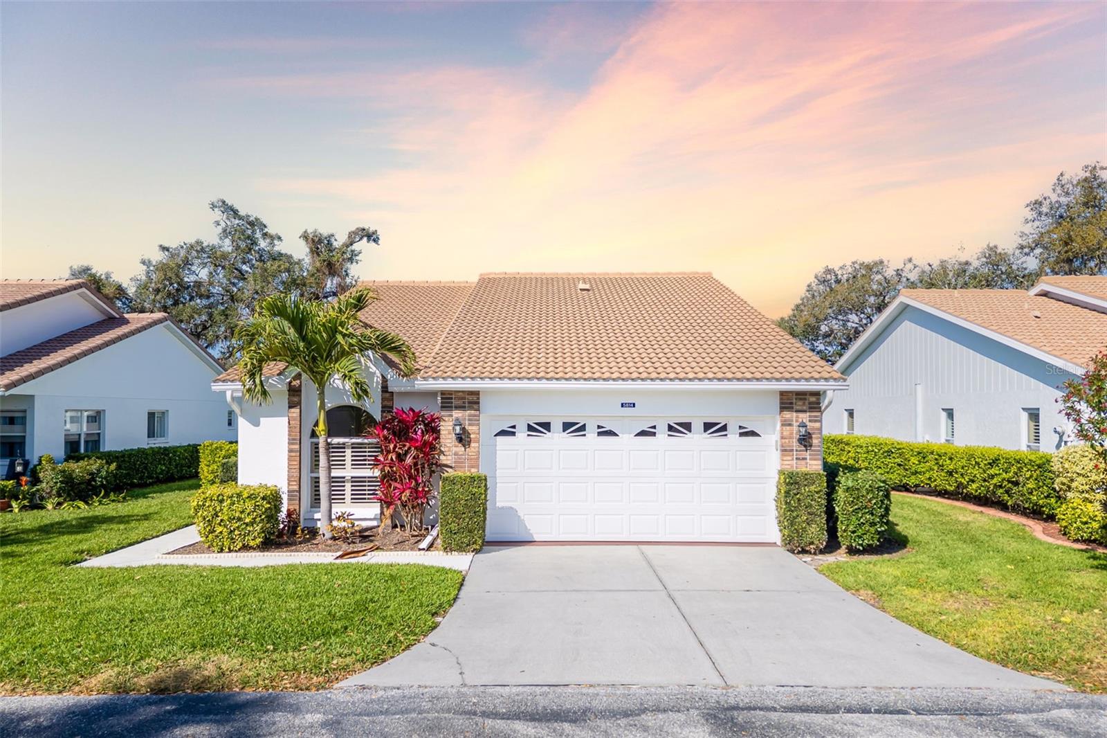 Take advantage of the NEWEST LOWER PRICE, NEW FLOORS and NEW EPOXY PAINT IN GARAGE. Welcome home to this charming, maintenance-free, standalone home featuring 3 bedrooms, 2 bathrooms, and a spacious 2-car garage, nestled in the beautiful 55+ gated community of Garden Lakes. Step inside to discover a bright and airy great room, complemented by an inviting eat-in kitchen perfect for casual dining and a formal dining room to entertain your friends for the holidays. The expansive Florida room offers incredible versatility and can easily adapt to your lifestyle. Relax or entertain on your screened lanai, a tranquil spot to enjoy your morning coffee or dine al fresco beneath lush trees and mature landscaping. Garden Lakes is known for its picturesque winding streets shaded by towering oaks and friendly neighbors who make it feel like home. Community amenities are exceptional, featuring a large heated pool, a recently updated clubhouse complete with a full kitchen, spacious dining area, fitness center, library, tennis, pickleball and shuffleboard courts, and scenic walking trails. Engage in a vibrant social life with numerous community events, including parties, day trips, potlucks, educational classes, and various card groups. Conveniently located close to shopping, dining, medical facilities, and the area's renowned cultural events, this home offers the best of Florida living. Schedule your private showing today! Buyer and/or buyer's agent should verify all measurements.
