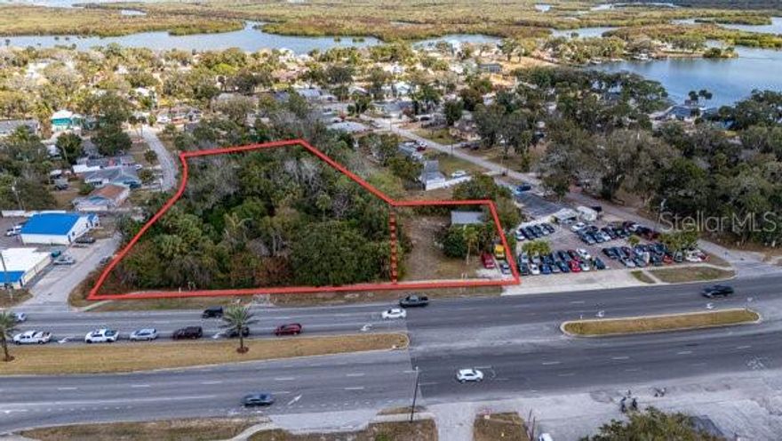 SUBJECT REAL ESTATE ENTAILS TWO COMMERCIALLY ZONED (MU) PARCELS ENCOMPASSING ~1.66 ACRES MAINTAINING A COMBINED ~310 LF OF ROAD FRONTAGE ON THE EAST SIDE OF US HWY 1 (S RIDGEWOOD AVE) IN THE HARBOR OAKS AREA OF PORT ORANGE. THE SITE IS CLOSE TO THE MAIN SIGNALIZED INTERSECTION & JUNCTION OF US 1 & STATE ROAD 5A (S NOVA ROAD), WHICH IS WELL TRAVELED AT AN AADT COUNT OF 28,500+/- VEHICLES. THE PARCEL AT 5919 S RIDGEWOOD CONSISTS OF ~56,380 SF OF MOSTLY WOODED LAND WITH REMNANTS OF AN EXPIRED 1924 STRUCTURE THAT STILL EXIST ON SITE. THE 5929 S RIDGEWOOD CONTAINS A TWO STORY DWELLING WITH GARAGE SPACE AND AMPLE PARKING ALL SITUATED UPON A ~17,860 SF PARCEL OF LAND DIRECTLY ABUTTING TO THE SOUTH. THE DWELLING WAS CONSTRUCTED IN 1934 AND ERECTED OF CB (PAINTED) AND NOW MAINTAINS A METAL ROOFING SYSTEM WITH ~1,080 SF OF INTERIOR SPACE THAT IS FULLY CLIMATE-CONTROLLED.
