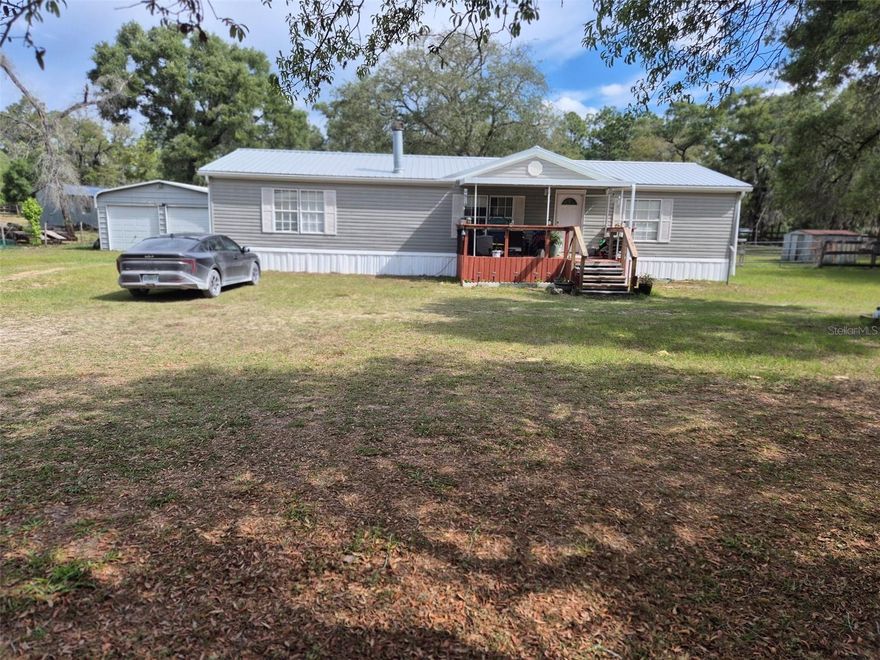3 BEDROOM 2 BATH DOUBLE WIDE IN WILLISTON HIGHLANDS UNIT 5! This well maintained 3/2 on 1.25 acre located just 1/4 mile off St Rd 121. Beautiful 1.25 acre lot features oak trees for shade, fenced back yard for the fur babies. 20' x 20' two door garage and 10' x 16' shed provides plenty of storage. Inside this home features over 1,500 sq. ft. of living area, a spacious primary bedroom with large walk in closet, with bathroom that includes garden tub and stall shower. Split bedroom plan offers 2 nice size bedrooms with walk in closets and guest bathroom. Kitchen/ Dinning room combo offers plenty of space for entertaining. Living room offers plenty of room for the family and wood burning fireplace makes it nice and cozy for winter nights. Appliances don't convey so treat yourself to brand new set of your choice. Make your appointment today to view your next homestead.