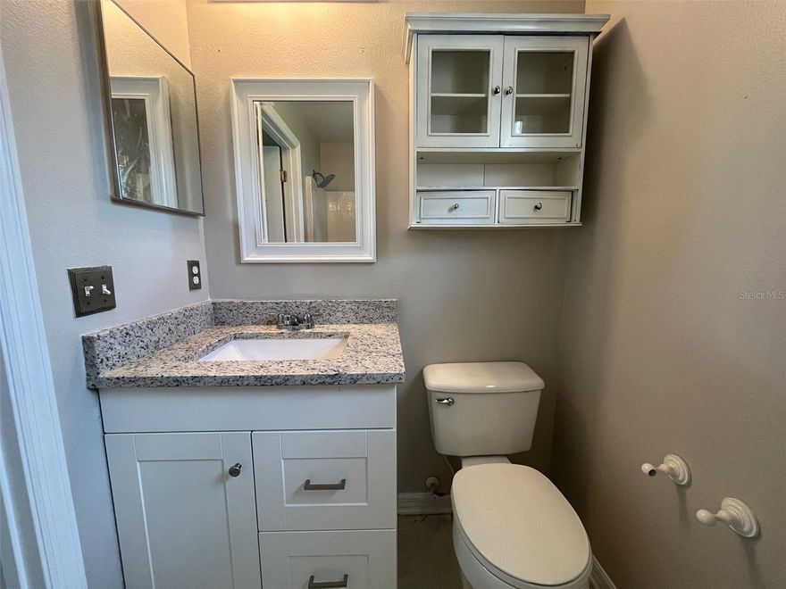 A gorgeous home in great shape on a quiet residential street. Imagine, after a long day, arriving to tranquil front yard with tropical and fruit trees, then relaxing in the oversized, fenced back yard. Home has many upgrades, including ceramic tile and brand new laminate flooring. New carpet being installed in master bedroom and all new interior paint. Brand new kitchen cabinets and granite counter tops. This home has a great split floor plan and is close to the theme parks, shopping, transportation, community college and hospital. Shows very well and won't last long at this price. Call today.