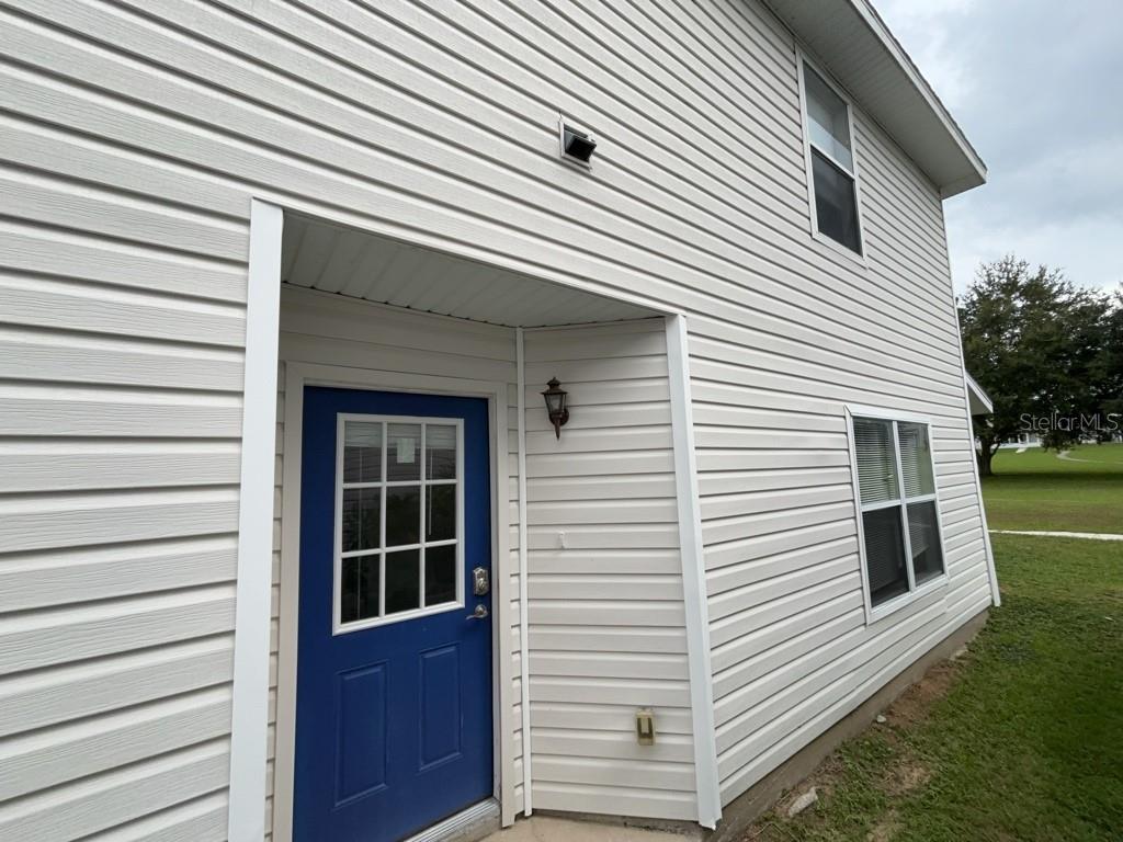 Freshly updated and move-in ready, this home sits in a community wrapped around a park, offering green views and convenient trail access. The main level features an open living/dining/kitchen layout with a remodeled kitchen that feature new shaker cabinets and quartz countertops, plus a primary bedroom on the first floor. Remaining three bedrooms located on second floor. A back patio opens to the walking trail. Parking is easy with a detached 2-car garage and two additional driveway spaces. Recent improvements include fresh interior paint and the kitchen remodel. Located in Groveland with quick access to shopping, dining, downtown Groveland, Publix, Dunkin’, Walgreens, and extensive walking/biking paths connected to the Lake County chain of lakes. No HOA.
