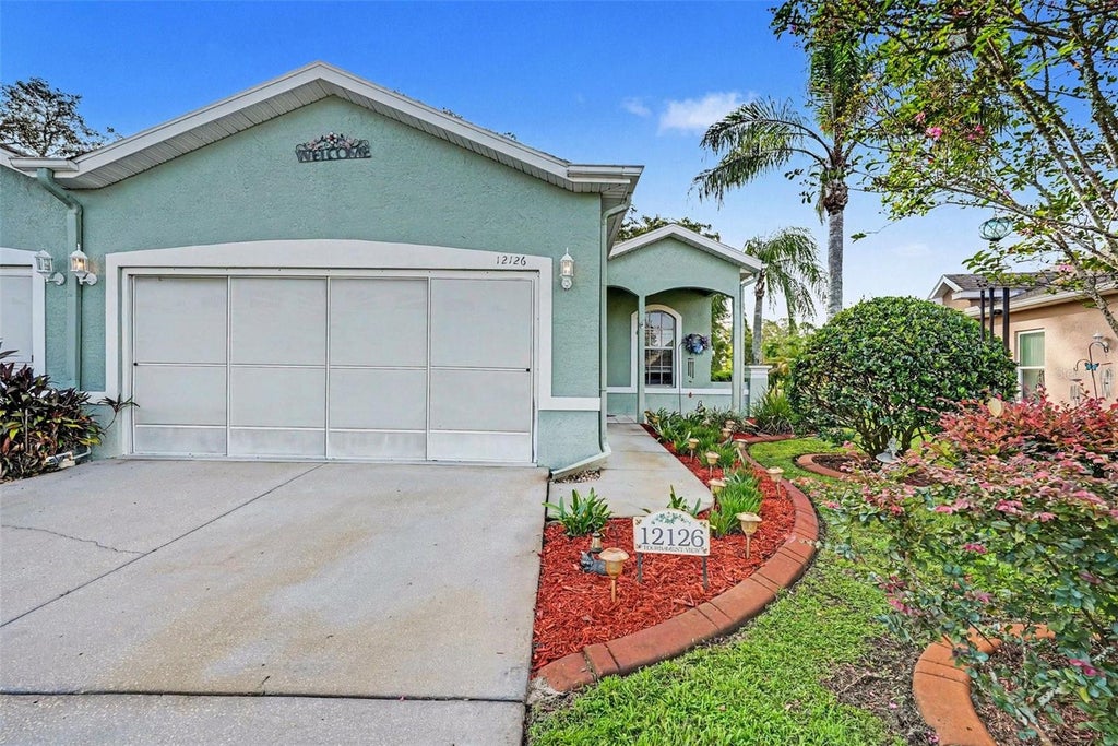 Photo of 12126 Tournament View Ave, New Port Richey, FL 34654 (MLS # TB8542743)