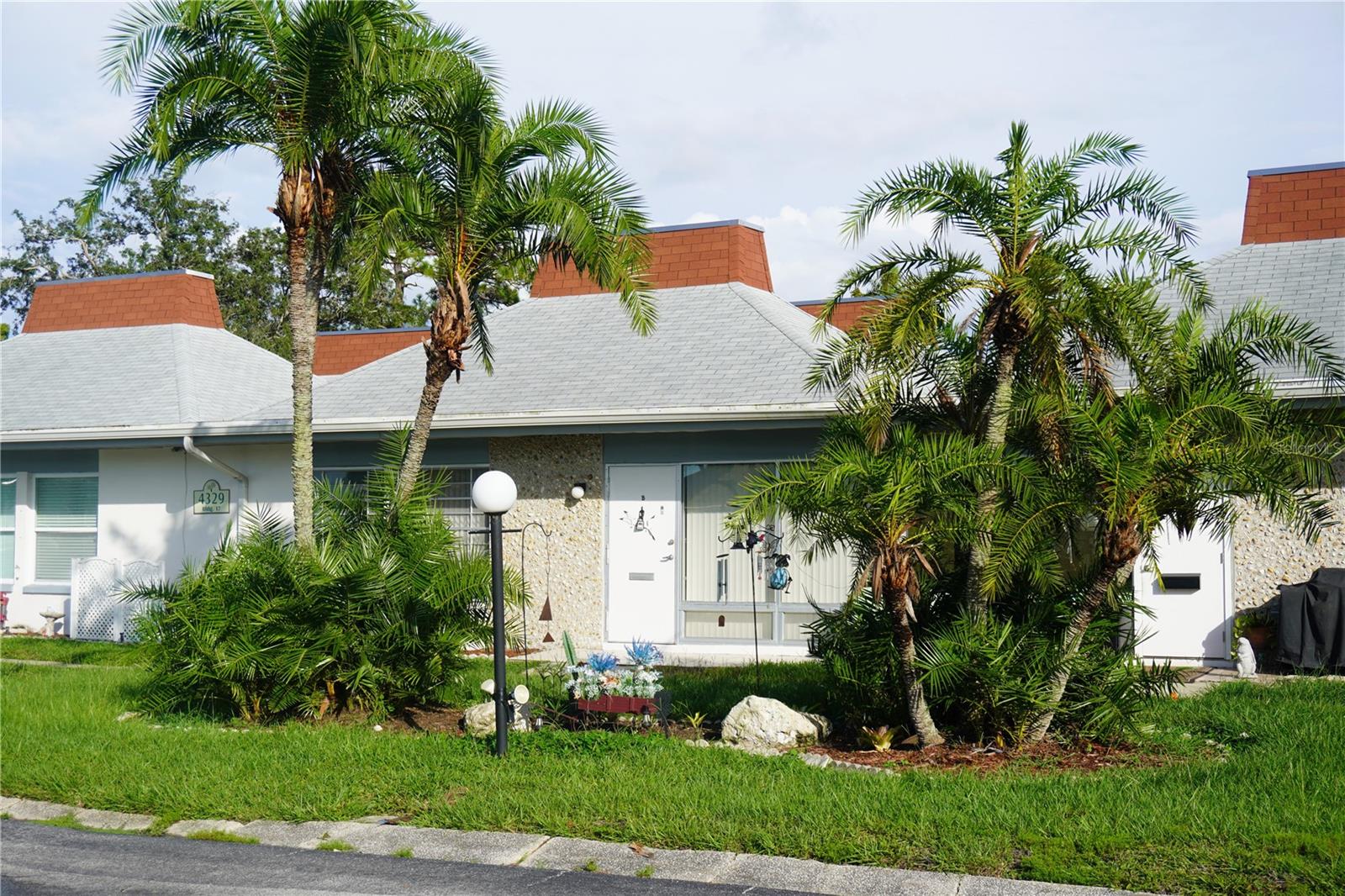 Welcome to this move-in ready two-bedroom, one and a half-bath condo in the desirable 55+ gated community of Tahitian Gardens. The open-concept layout offers a bright, inviting atmosphere, with a spacious primary bedroom with a large closet. Recent updates include laminate flooring throughout and fresh paint on all interior walls and doors. Enjoy the convenience of in-unit laundry, tinted windows, and a dedicated parking spot close to your doorstep.
Tahitian Gardens is a well-maintained community with access to amenities including a clubhouse, heated pool, recreation center, shuffleboard, and more. Relax on your patio with scenic views or walk across the street to the lake and fountains. Shopping, dining, and entertainment are nearby. It is just a short drive to the Tarpon Sponge docks, Sunset beach and the beach at Fred Howard Park. Tampa and St. Petersburg airports are less than 45 minutes away. Easy to see, schedule your showing today!