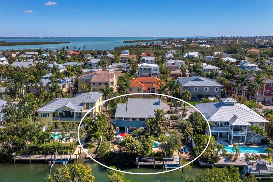PRICE REDUCTION! Coastal elegance meets relaxed island living in this beautifully renovated and fully furnished Key West–style waterfront retreat on Longboat Key. Offering boating, beach, and three bedrooms and three full baths, this thoughtfully designed home also features a private guest/in-law suite complete with its own full bath and kitchenette—ideal for extended stays or visiting family and friends.  Step outside to your own tropical oasis, where a heated in-ground pool and expansive paver lanai create the perfect setting for alfresco entertaining. The well-protected canal frontage includes a private dock with boat lift, water, and electric, providing effortless access to Sarasota Bay, the Intracoastal Waterway, and the Gulf. Boating enthusiasts will appreciate the direct, easy navigation, while beach lovers will enjoy the nearby neighborhood beach access just a short stroll away.  Inside, the open great room floor plan showcases plank wood flooring, a cozy fireplace, and an expansive Florida room overlooking the water. The well-appointed kitchen features gas cooking and generous workspace—perfect for the home chef. The spacious main-level primary suite offers a walk-in closet and private en-suite bath, while a separate guest bedroom and adjacent full bath provide comfort and privacy.   On the ground level, the fully appointed in-law / guest suite opens directly to the pool and lanai area and includes a full bath and new kitchenette. A versatile bonus space offers endless possibilities—game room, fitness studio, hobby space, or additional lounge area.  Recent improvements include a new roof, Florida room addition with impact windows, Hardie board siding, in-law / guest suite kitchenette cabinets and appliances, and more. Lush tropical landscaping, raised planting beds, a kayak launch, paver drive and walkways, privacy fencing, and a welcoming front porch complete the exterior appeal.  Located in the friendly Norton Street neighborhood, residents enjoy a voluntary social homeowners association with regular gatherings—one of the many reasons this is considered one of the island’s most desirable year-round communities.  Waterfront luxury. Easy boating. Close to the beach.  601 Norton is your opportunity to embrace the very best of island living.