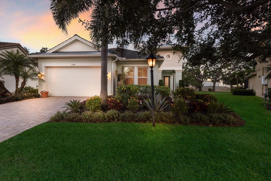 WELCOME to your DREAM home in the sought after community of Savanna in Lakewood Ranch!!! This BEAUTIFULLY upgraded 2 bedroom, 2 bath, plus den, Alexander model by Meritage offers 2,088 square feet of comfortable one story living with a perfect blend of elegance, function, and warmth. As you enter, you’re welcomed by a VERSATILE den or office with double glass French doors, ideal for working from home or creating a quiet retreat. Step further inside to discover a light filled open floor plan where the SPACIOUS living room invites you to relax while enjoying peaceful views through large glass sliders that lead to your covered and screened paver lanai. The chef’s kitchen is a standout with quartz countertops, a tiled backsplash, a kitchen island with casual seating, a dual stainless steel sink, and KitchenAid stainless steel appliances. An ABUNDANCE of cabinetry and a walk-in PANTRY with built-in shelving make organization a breeze. Off the kitchen is an additional dining area, perfect for more formal gatherings, with a second set of sliders overlooking your beautiful backyard. The spacious owner’s suite is tucked away for privacy and features an ENSUITE bathroom with dual sinks, a vanity makeup area, and a walk-in tiled and glass shower with a built-in BENCH. A MASSIVE walk-in closet completes this SERENE retreat. The second bedroom is located on the opposite side of the home, offering PRIVACY for guests and includes a full bath with dual sinks and a tiled tub/shower combo. After a long day, unwind in your TRANQUIL backyard oasis, with plenty of room to add a pool or create a spacious play area for pets and family. The lush TROPICAL landscaping enhances the sense of serenity and privacy. This home includes numerous UPGRADES such as plantation SHUTTERS throughout, a central IN-WALL vacuum system, a whole-house Generac GENERATOR with a 7 year service contract, a newly updated laundry room with an added sink and cabinet, new toilets recently installed, custom garage cabinetry and an EPOXY coated garage floor. This move-in ready home has everything you need to start making lasting memories with loved ones. Savanna is a fabulous community with LOW HOA resort-style amenities such as a clubhouse, swimming pool, state-of-the-art fitness center, basketball courts, playground, dog park and numerous walking paths. Lakewood Ranch is known for their A+ rated school system and is perfectly located just a short ride to downtown Sarasota, St. Pete, world class shopping, fine dining and the FAMOUS Gulf beaches! Don't wait to make this your home and begin your FLORIDA Lifestyle!
