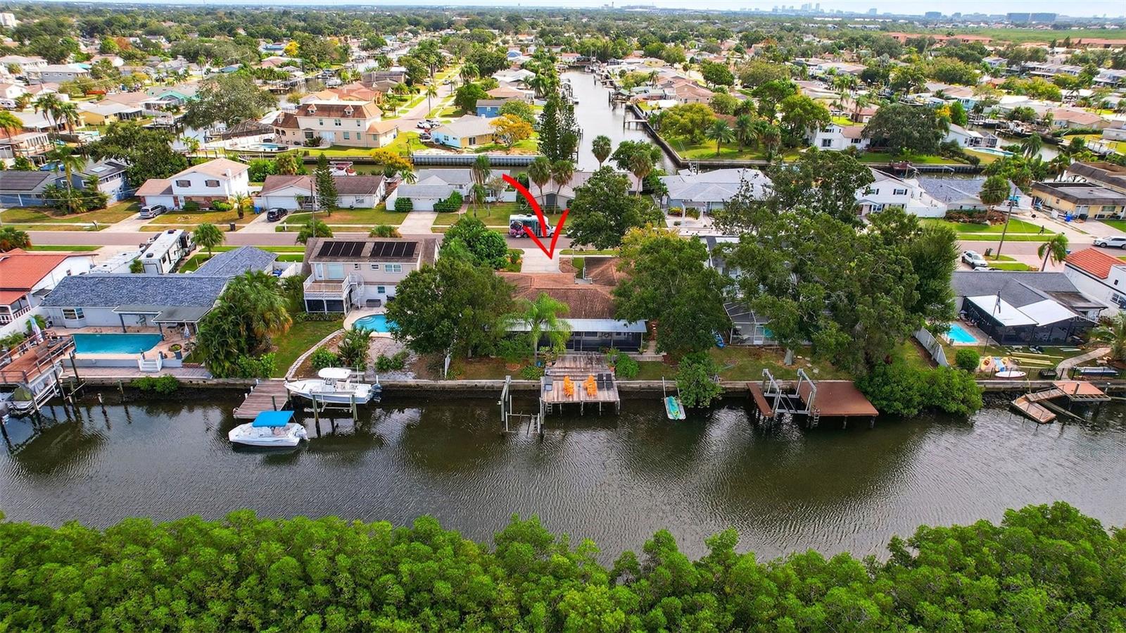 Boaters, secure your slice of coastal living before prices rise like the tides! This waterfront setting is a true highlight, with the home positioned to take full advantage of the serene views overlooking the adjacent preserve and immediate access to Tampa Bay for boating, fishing and cruising to one of many waterfront restaurants. The renovated and open floor plan, approximately 1,879 square foot, showcases a thoughtful blend of modern updates and classic charm. Ideal for entertaining inside and out, the kitchen and living areas overlook the patio and waterfront. The 8,000 lb boat lift is ready for your favorite vessel, or just fish right from your dock! This property overlooks the multi-million dollar homes of TroyDale as well as the brilliant, tropical sunsets which will inspire you nightly.
Located only 15 minutes to Tampa International Airport and 30 minutes to Clearwater Beach, this home is ideal for full-time residents or snowbirds in search of salt air and sunshine. With hurricane windows throughout, safety is priority. Recent renovations allow you to bring your own sense of style and start enjoying waterfront living right away...without any HOA fees.