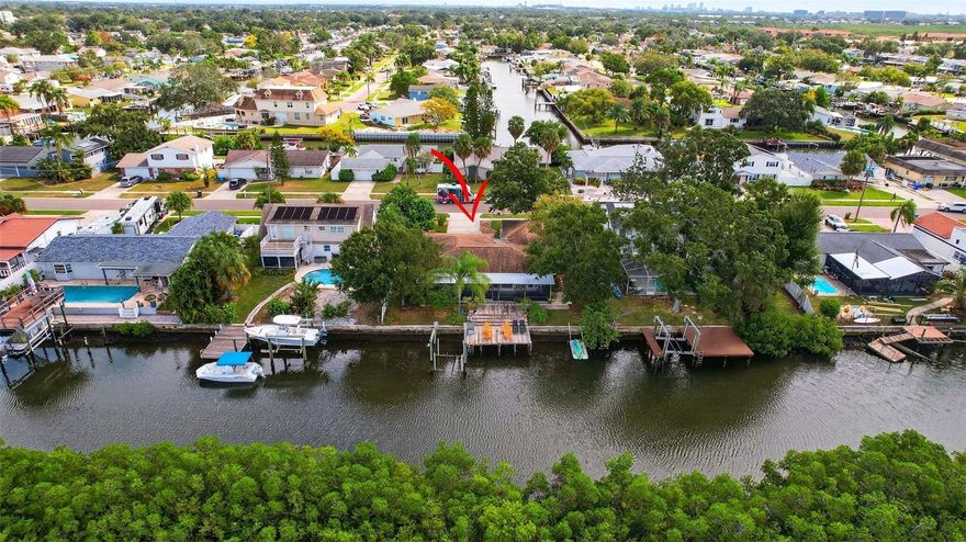 Boaters, secure your slice of coastal living before prices rise like the tides! This waterfront setting is a true highlight, with the home positioned to take full advantage of the serene views overlooking the adjacent preserve and immediate access to Tampa Bay for boating, fishing and cruising to one of many waterfront restaurants. The renovated and open floor plan, approximately 1,879 square foot,  showcases a thoughtful blend of modern updates and classic charm. Ideal for entertaining inside and out, the kitchen and living areas overlook the patio and waterfront. The 8,000 lb boat lift is ready for your favorite vessel, or just fish right from your dock! This property overlooks the multi-million dollar homes of TroyDale as well as the brilliant, tropical sunsets which will inspire you nightly.
Located only 15 minutes to Tampa International Airport and 30 minutes to Clearwater Beach, this home is ideal for full-time residents or snowbirds in search of salt air and sunshine. With hurricane windows throughout, safety is priority. Recent renovations allow you to bring your own sense of style and start enjoying waterfront living right away...without any HOA fees.