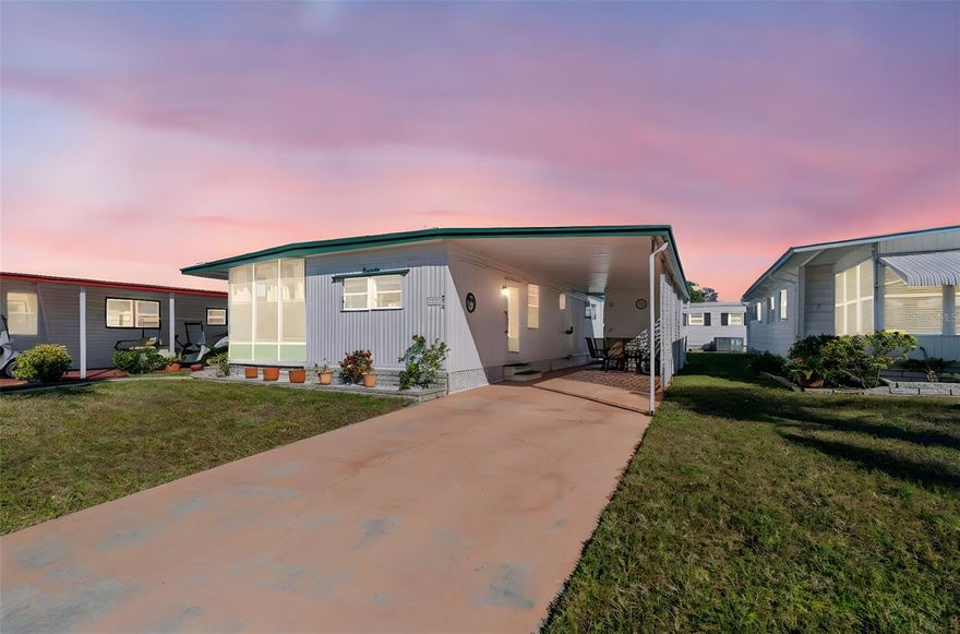 A charming mobile home nestled within the age-qualified park of Four Seasons Estates. This home ideally situated, close to the Pool and Clubhouse offers a serene and welcoming community atmosphere for those seeking a comfortable and convenient lifestyle. This 2 Bedroom, 2 Bathroom residence provides an ideal blend of modern amenities and cozy living spaces. From the  covered carport area you are greeted by the convenience of a large area for 2 cars and an outside sitting area to enjoy the Florida Lifestyle. The shed provides additional storage for all your beach gear. Step inside the  light and bright open floor plan with a designated dining space including a built in hutch great for storage. The kitchen is spacious and offers a coffee bar /desk area.  The ample counter space and built in pantry are just some of the extra features in this well appointed kitchen. The wall of windows allow for natural light to flow in giving this home a bright and sunny appeal. Sliders lead to the Sunny enclosed Florida room. great for catching a Florida Sunset! The primary bedroom is large and fits a king size bed, 2 large closets as well as an en suite Bathroom.  The second bedroom is large and also has a washer and dryer in the cloet adding extra convenience.  This unit is being sold completely furnished with all you need to make this a perfect winter retreat. Close to the pool and clubhouse, golf cart friendly, with tons of social activities, and walking distance to shopping, restaurants, movies and more!! Four Seasons backs up to Lake Seminole and is just 4 miles to our World Famous Beaches, 2 Major Airports, Downtown St. Petersburg for Arts and a Rays game,or a short drive across the bridges to Tampa or Sarasota!! "Live Large in the Sunshine State on a small Budget!" This adorable and affordable home offers an abundance of space and comfort. Boasting a generous floor plan, this home features multiple living areas, perfect for entertaining guests or relaxing with family. $285 Monthly fee includes Water, Trash, and Lawn service, Pool, shuffleboard, clubhouse, onsite management and more. So take a stroll along Lake Seminole, fall in love with Four Seasons today.