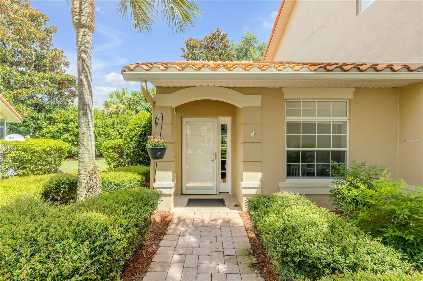 Resort-Style Living on beautiful Lake Miona! No rear neighbors and NO BOND! Welcome to the premier all-ages neighborhood inside The Villages Central Area—where comfort, convenience, and lifestyle come together. This spacious ground-floor end-unit condo offers a private entrance, attached garage, and maintenance-free living—perfect as a full-time residence or seasonal retreat.
Inside, cathedral ceilings and Luxury Vinyl Plank flooring create an open, airy feel. The kitchen boasts Corian countertops and newer appliances, while the dining room is perfect for entertaining. The primary suite includes dual sinks, a tiled step-in shower, and a walk-in closet. A generous second bedroom and bath provide space for guests. Inside laundry provides convenience. Relax in your large screened lanai overlooking peaceful green space—ideal for morning coffee or evening wine.
Community amenities rival a resort: clubhouse with fitness center, billiards, library, banquet hall with catering kitchen and dance floor, plus TWO pools (one resort-style, one smaller with spa). Stay active with tennis, pickleball, basketball, putting green, playground, and outdoor fitness equipment.
This gated community includes maintenance-free living! Don’t miss your chance to own in the only all-ages, resort-style neighborhood right inside The Central Villages area!