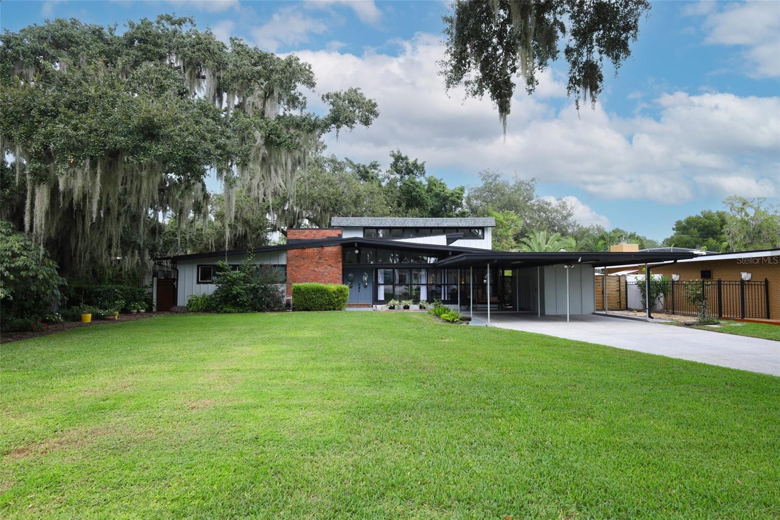 Discover this exceptional mid-century modern beauty tucked away on a peaceful, tree-lined street in the sought-after community of Belle Isle. Situated on over a quarter-acre of serene landscape, this home offers both tranquility and convenience.
Step inside to find soaring ceilings that will take your breath away, with formal living, dining, and great rooms that flow seamlessly—perfect for family gatherings and entertaining. Featuring 3 spacious bedrooms and 2 full baths, this residence offers over 2,000 square feet of comfortable living space.
You’ll love the abundant storage throughout, including covered outdoor parking and a long driveway for guests—plus, street parking is allowed! The timed sprinkler system keeps your yard lush with ease.
Boating enthusiasts will appreciate the public boat ramp to the Conway Chain of Lakes just down the street, while the home’s prime location provides quick access to shopping, dining, the airport, and area attractions.
Don’t miss your chance to experience this peaceful Belle Isle retreat—it’s truly one of a kind!