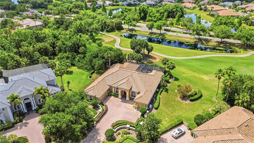 Perfectly placed on over a half acre at the end of a quiet cul de sac inside Waterlefe Golf & River Club, this home delivers something genuinely hard to find in a golf course community: privacy that does not feel compromised.

Positioned on a rare, baseball diamond shaped lot, the home opens wide across the golf course with no neighboring homes visible from the back. From the lanai, pool, and main living areas, the view is uninterrupted, calm, and expansive. You get the beauty of the course without feeling like your backyard is part of everyone else’s afternoon. It is the kind of setting that immediately stands out, and one that rarely comes available.

Waterlefe is one of Bradenton’s most distinctive gated communities, known for blending golf, riverfront scenery, boating, kayaking, dining, fitness, and social connection into everyday life. Set along the Manatee River, it offers a lifestyle that feels active without being busy and refined without being overdone. Whether it is time on the course, evenings at the club, a workout, or a quiet paddle on the river, the lifestyle is already built in.

Inside, the home reflects a style that has largely disappeared from newer construction. Arched openings, columns, lighted tray ceilings, a fireplace, and warm architectural detail create a sense of scale and character that feels established rather than trendy. It is elegant without being formal, and comfortable without feeling casual.

The layout is designed for how people actually live. A formal living room, true family room, and additional sitting area each serve a purpose, giving you space to gather, host, or simply step away without losing the flow of the home. The renovated kitchen blends bright finishes with classic architectural detail, creating a space that feels updated without losing character. A separate butler pantry and bar with wine fridge make entertaining feel easy and organized.

A dedicated office, formal dining room, and casual eat in area add flexibility for everyday life, hosting, and work when needed. The primary suite is positioned for privacy and comfort, with direct access to the outdoor living space.

Out back, the screened lanai becomes the center of daily life. The pool and spa are anchored by a rock waterfall feature that adds sound and movement without overwhelming the space. The outdoor kitchen makes it easy to enjoy dinner outside, host friends, or settle into a long Florida evening without constantly heading back indoors. With no rear neighbors in sight, the entire setting feels calm, open, and entirely your own.

Practical upgrades add another layer of confidence, including an almost new roof, whole house generator, and remote control hurricane shades. The home may also be sold furnished, making the transition even simpler for the next owner.

This is more than a home with a golf course view. It is a private, well designed Waterlefe residence where everything has already been thought through. No projects. No compromises. Just a home that lives the way it should.