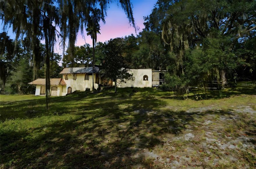 Sitting on over 2 gorgeous acres beneath a canopy of old Florida skies, this multi-level home is a rare find—original, untouched, and brimming with potential. Bring your contractor and vision: the residence is in its original state and needs a complete renovation, yet the bones, setting, and scale make the opportunity undeniable. A flexible floor plan offers entrances to both the upstairs and downstairs—an ideal setup for multi-generational living, a private guest retreat, or studio/workspace separation (verify use with county).

The property shines outdoors: a substantial 10-stall horse barn with multiple potential uses (equestrian, car collection, hobby space), several outbuildings for storage, and a detached 2-car garage with bathroom. Sprawl out, spread out—there’s room here for gardens, trailers, boats, and the lifestyle you’ve been planning.

Love where you live: just minutes to Blue Spring State Park (manatees, trails, kayaking) and the St. Johns River for world-class boating and fishing. Everyday convenience is close by—Medical, Publix, Target, entertainment and dining —while Historic Downtown DeLand adds boutiques, cafés, and arts. Commuters will appreciate quick access to I-4, SunRail DeBary, and easy drives to Orlando, Daytona, and New Smyrna Beach.

If you’ve been searching for a blank canvas with acreage, original charm, and big-sky possibilities—this is it. Create your Florida homestead, equestrian setup, or multi-gen abode in a location that delivers both nature and convenience. (Property sold as-is; renovate to your style and standards.)