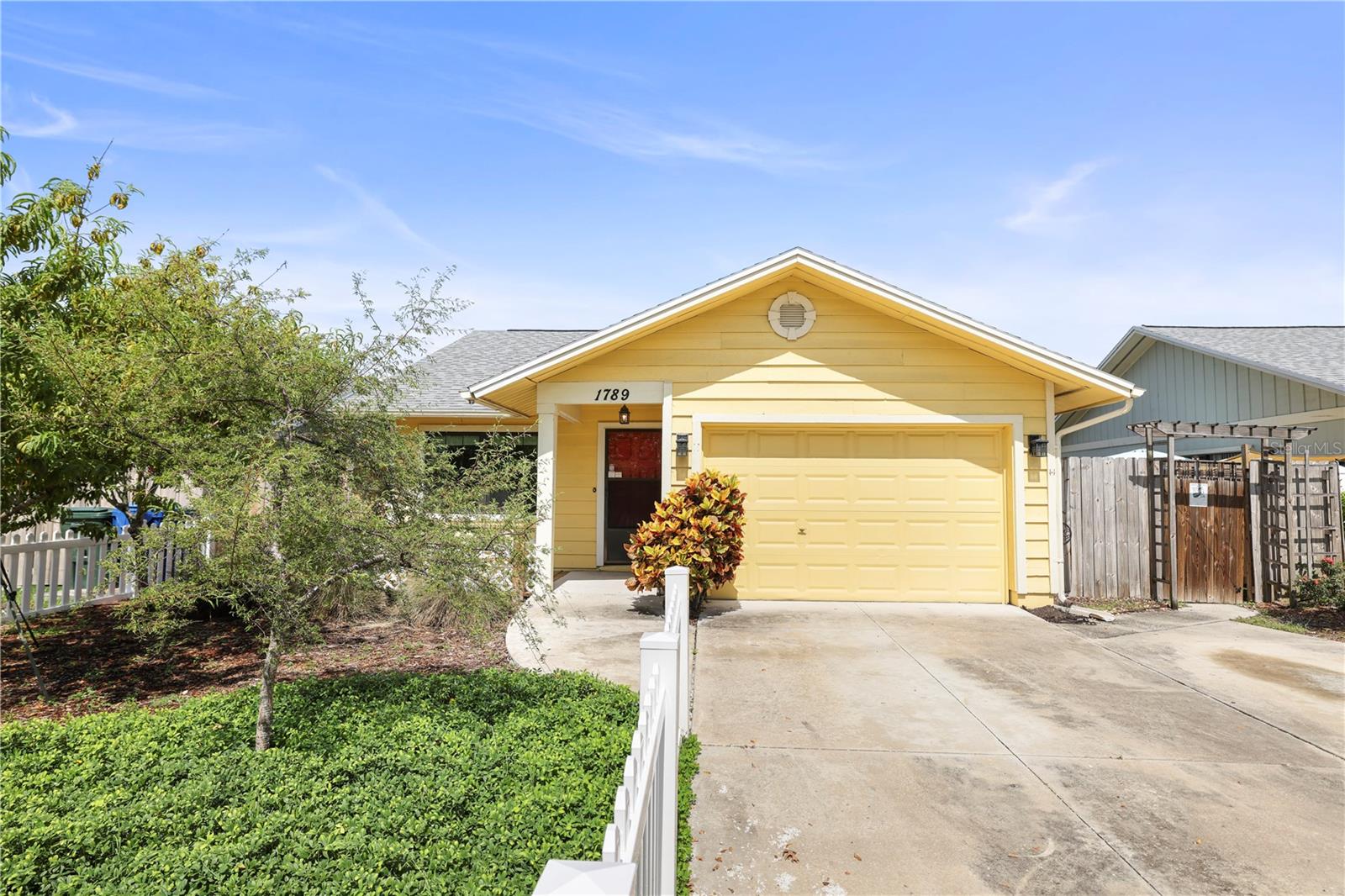 From the moment you arrive, you will be greeted with the bountiful Crepe Myrtle Trees lining the sidewalk in front of the home. As you walk up the driveway, you will see the blooming fruit trees including a peach, plum, fig and pear trees in the thoughtfully designed yard space; designed to be beautiful and edible but also to attract butterflies WITH NO MOWING REQUIRED! The home has a welcoming front porch and the moment you step inside the home, you will notice the HIGH CEILINGS and LIGHT AND BRIGHT LIVING SPACE with built in shelving and SLIDERS TO THE OUTDOOR PATIO AREA; perfect for dining alfresco or entertaining outdoors. The dining area is next to The UPDATED GALLEY STYLE KITCHEN WITH a fun tropical tile backsplash. There are 2 PRIMARY BEDROOMS AND A BONUS ROOM. The garage was also converted into even more air conditioned living space with a dedicated laundry area and an additional 1/2 bath, could also be used as additional pantry/storage space. This home has been very well maintained over the years and has had some recent improvements including VINYL HURRICANE IMPACT RATED WINDOWS AND SLIDING DOORS! Roof was replaced in 2018. NO HOA and NO FLOOD ZONE means REDUCED MONTHLY EXPENSES AND STRESS! The subdivision of Tall Pines has a nice community feel and even features sidewalks throughout the neighborhood, perfect to stroll thru the neighborhood or walk the dogs. Centrally located in Pinellas County; right off Ulmerton Road and is zoned as Unincorporated County. Easy access to US 19, I275 , Close to SEVERAL BEAUTIFUL PARKS, PLAYGROUNDS, GULF BEACHES, SHOPPING AND DINING! So much to enjoy about Largo & the surrounding area! Room sizes are approximate and provided as a courtesy. Property is an estate sale.