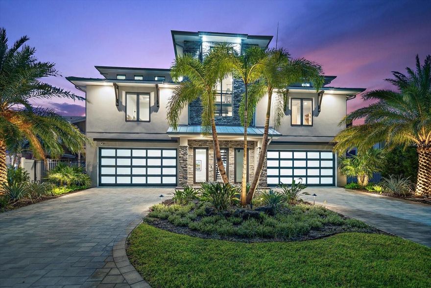 Spectacular customized new residence! With the final touches complete, this recently constructed custom home offers a move in ready experience, bypassing the usual challenges and waits associated with new construction. Dare to compare this new modern coastal property built by renowned Campagna Homes of Tampa Bay. Expertly engineered for peace of mind and constructed with uncompromising quality, every detail of this smart home reflects thoughtful craftsmanship, cutting-edge design, setting a new standard for luxury waterfront living. 
Situated on a premium waterfront lot with breathtaking uninterrupted water views from the intracoastal to the blue waters of the Gulf of Mexico, this home offers the pinnacle of Florida living. An atrium entry is stunning! Step inside to soaring ceilings and a dramatic floating staircase accented by a bold blue agate feature wall. The expansive great room, kitchen, and dining area flow seamlessly to the outdoors through accordion-style doors that fully open to a wide verandah overlooking panoramic views of the Intracoastal Waterway, dotted with spoil islands and framed by Caladesi and Honeymoon Islands. The kitchen and bathrooms throughout the home are elevated, artistic, and curated with intention. Natural stone, marble, dramatic tile, designer lighting, bespoke mirrors and plumbing fixtures were carefully selected to create a cohesive sense of style and sophistication. The chef’s kitchen is a showpiece, featuring three ovens, a warming drawer, six-burner gas range with pot filler, stainless steel hood, wine fridge, and ice maker—all crafted to both impress and perform.
Additional highlights include a richly appointed glass-enclosed study with custom-built-ins, a luxurious home theater (or 4th bedroom), and a saltwater pool perfect for entertaining or peaceful relaxation. The dock offers a covered slip and a separate low-profile platform for easy kayak and paddleboard launch or a jet ski. A whole house generator, elevator and safe room add to the list of features which make this residence exceptional.  
Located 30 to 45 minutes from Tampa International Airport, St. Pete, and Clearwater, this property is your gateway to Gulf Coast beaches, nightlife, arts, and professional sports, and best of all, just a golf cart ride to the charm of Dunedin, one of Florida's most beloved coastal towns.