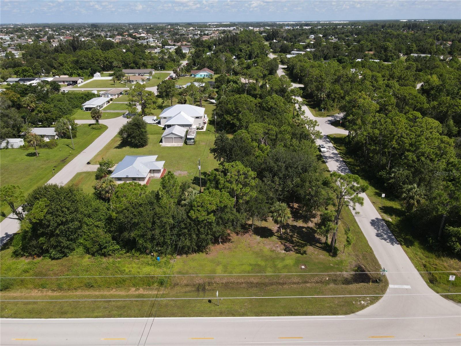 Discover this rare opportunity in South Punta Gorda Heights! This OVERSIZED CORNER parcel includes 4 COMBINED LOTS offering ample room for your future home or investment project. The property already has CITY WATER access, high-speed INTERNET availability, and overhead ELECTRICAL lines in place. A COMPLETED SURVEY provides peace of mind, while the land has been CLEARED of debris yet maintains beautiful mature trees for natural shade and privacy. Enjoy a quiet setting while being just a short drive to downtown Punta Gorda, shopping, dining, I-75, and everyday conveniences. Don’t miss your chance to own this oversized corner lot in a growing area of Punta Gorda!