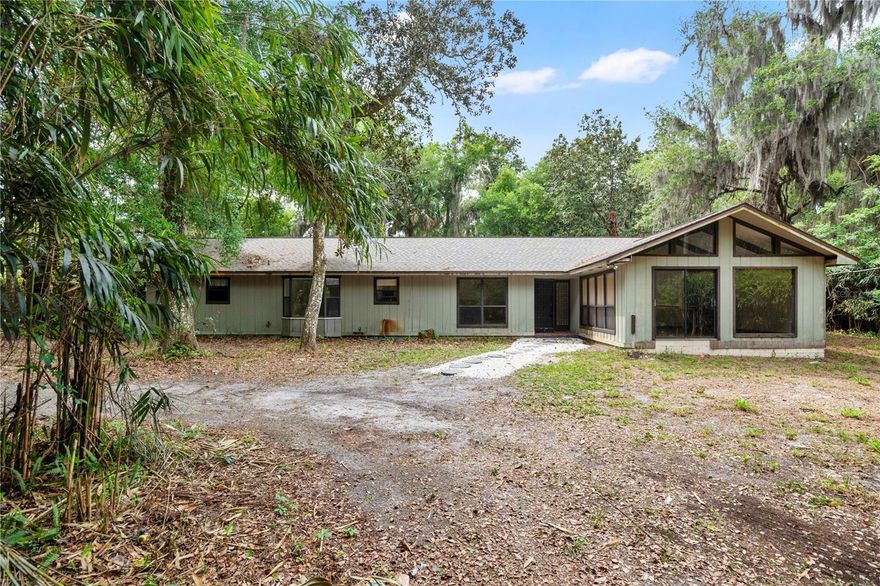 Nestled on approximately 1.61 pristine, high-and-dry acres of picturesque property, this remarkable 4-bedroom, 3-bath estate offers an extraordinary blend of privacy, comfort, and boundless potential. Built in 1974, this expansive single-story residence encompasses 2,523 square feet of thoughtfully curated living space, highlighted by soaring ceilings, abundant natural light, generous storage, and a flowing, open-concept design that feels both airy and inviting.

At the heart of the home, the spacious and sun-drenched main living area creates a warm, welcoming atmosphere—perfect for both relaxed everyday living and effortless entertaining. The serene and secluded primary suite serves as a true retreat, featuring an appointed en-suite bath designed for both comfort and tranquility. Three additional generously sized bedrooms and two full bathrooms provide exceptional versatility for guests, a stylish home office, creative studio, or multi-generational living.

Step outside and experience the true magic of this property. The sprawling 1.61-acre parcel is beautifully treed and entirely usable, offering a rare canvas for your dreams. Whether you envision privacy and lofty pursuits, lush gardens, a private workshop, space for recreational vehicles, or simply the quiet luxury of wide-open land, this property delivers unmatched flexibility and freedom. With no HOA restrictions, you have the rare opportunity to create a lifestyle that is both expansive and uncompromised.

Perfectly positioned in the charming community of Geneva, this property captures the essence of peaceful, rural living while remaining conveniently connected to Oviedo, Sanford, Chuluota, and major roadways. Enjoy the best of both worlds—tranquil surroundings paired with easy access to shopping, dining, and everyday conveniences.

This is a truly rare and compelling offering—an expansive, site-built home set on over 1.6 acres of gorgeous land in one of Central Florida’s most desirable and increasingly sought-after areas. Properties of this caliber, character, and versatility are few and far between.
The schools are remarkable as well. Much sought after Geneva Elementary, Chiles Middle and Oviedo High. All wonderful with great grades.
Come see this home today and make it your own.