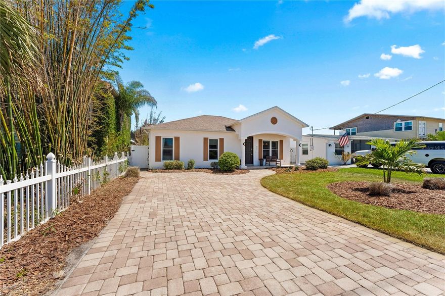 A truly rare find, this beautiful pool home in the highly sought-after community of New Smyrna Beach offers the perfect blend of modern comfort and coastal living—just 375 steps from the ocean. Completely furnished, the main residence features three bedrooms, two full baths, beautiful travertine flooring throughout, and high ceilings with a sun tunnel. A dramatic wall of oversized sliders creates a seamless indoor-outdoor living experience.  The home’s inviting layout welcomes you with open living, kitchen, and dining areas anchored by an electric fireplace. The kitchen is appointed with granite countertops, stainless steel appliances, soft-close custom cabinetry, a stylish tile backsplash, a farmhouse sink, and a large 7-foot center island for casual dining. The detached guest cottage/cabana/ADU provides a versatile fourth bedroom and third bathroom, complete with its own HVAC system and kitchenette. It can easily serve as an apartment, art studio, private office, fitness space, or playroom; offering exceptional flexibility for guests or creative pursuits.  Indoor-outdoor living comes effortlessly with an expansive, travertine-floored, covered lanai featuring a full summer kitchen, with both shaded and open-air lounging areas perfect for entertaining. Enjoy quiet relaxation in the in-ground saltwater pool and heated waterfall spa, surrounded by luxury pavers.  This home is serviced by city water and sewer and includes an irrigation well and Rain Bird sprinkler system. With no HOA restrictions, the freedom to enjoy coastal living at its finest is yours. Ideal as a rental investment property, it’s located just 900 feet from the beach with public access at the street’s end, or 940 feet west to the walking and biking trails along the mangroves and river on Saxon Avenue.  Just moments from New Smyrna Beach’s vibrant restaurants, boutiques, and local attractions—and a short drive south to Canaveral National Seashore and Kennedy Space Center—this residence perfectly captures the essence of the Florida coastal lifestyle. Come home to New Smyrna Beach—where every day feels like a vacation.