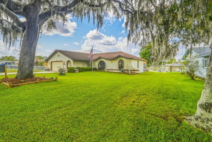 This waterfront gem, nestled in a cul de sac, features direct access to the scenic Tsala Apopka Chain of Lakes. Bonuses include: Roof 2017, AC 2024, large metal shed + 30 amp RV service installed. Enjoy the 480 sq ft deck, while watching the cranes stroll by with their babies. The sunset + sunrise from this home are not to be missed. Much of the flooring has been replaced with wood look vinyl. A cozy den overlooks the water with large windows. A bonus room which has sometimes been used for grandkids sleepovers, is a perfect craft/hobby room. An expansive kitchen overlooks a breakfast bar + separate dining room. In front of the concrete seawall lies your private dock—perfect for fishing or boating right from your backyard.