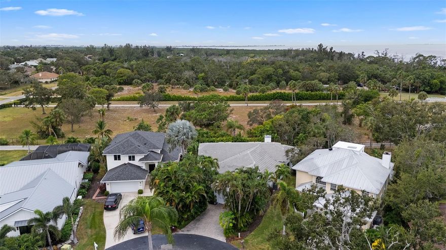 Welcome to relaxed Florida living in this inviting 3-bedroom home located in a sought-after, maintenance-free waterfront community in Northwest Bradenton. Residents here enjoy resort-style amenities including a heated pool and spa, tennis and pickleball courts, a clubhouse, and a beautifully updated fishing pier. Spend evenings watching the sunset, grilling outdoors, or dropping a line to catch dinner.

Amazing location! You’ll be just minutes from the award-winning beaches of Anna Maria Island, shopping, dining, and great schools.

Inside the home, large sliders and windows bring in natural light and create a seamless connection to the spacious screened lanai and private fenced backyard, complete with mature landscaping and western exposure for soft evening light. The living room offers soaring ceilings, leaded glass entry doors, and a fireplace that adds warmth and charm. The kitchen is open to the main living area and features a generous granite breakfast bar and abundant cabinetry, making it perfect for gatherings. A separate dining room is available for holidays or dinner parties.

All three bedrooms are located on one level in a split layout that allows for privacy. The primary suite is roomy and features elegant cherry flooring and direct access to the lanai. The additional bedrooms and hallway have recently updated oak flooring. Peace of mind comes from the nearly new tile roof and hurricane shutters, which performed beautifully during recent storms. The three-car tandem garage provides flexibility for storage, a workshop, or multiple vehicles. A drilled well and four-zone irrigation system help keep the yard looking lush without added water costs.

This home combines comfort, natural beauty, and a fantastic lifestyle. Come see it for yourself!