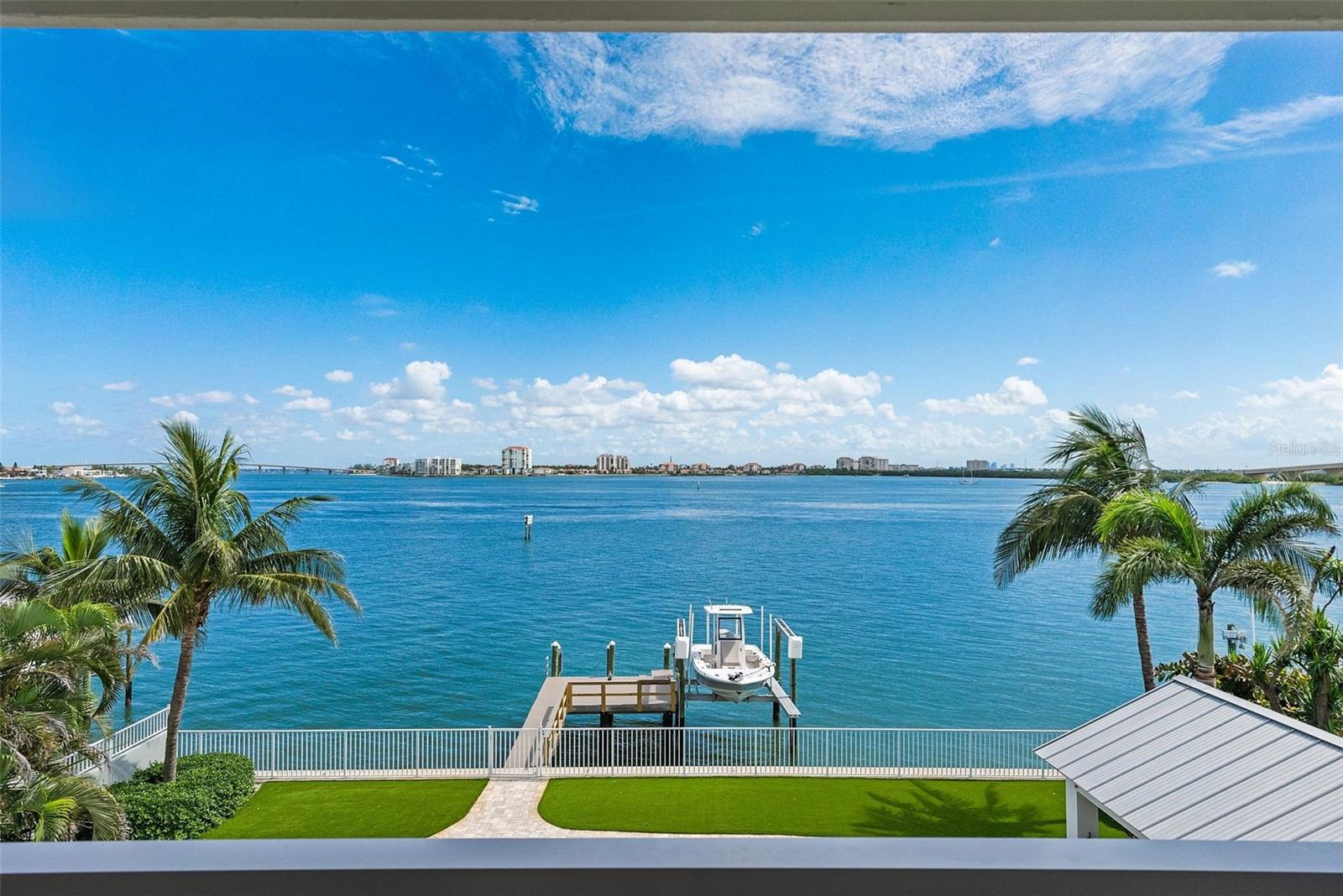 Simply stunning! Spend every single day relishing the sweeping, panoramic views of Boca Ciega Bay from this impeccably remodeled high-and-dry waterfront sanctuary on the exclusive island paradise of Tierra Verde. By day, sunlight dances across expansive waters; by night, the twinkling lights of the Don CeSar, St. Pete Beach, and Isla del Sol illuminate the horizon, creating an enchanting backdrop for island living at its finest.
The gracefully designed interior reflects coastal sophistication and casual elegance, with no element left untouched. This home is ready for you to move in and enjoy in the highest of style, no further work required.
The gourmet kitchen and primary bath feature luxurious Cambria quartz countertops paired with custom cabinetry, while the guest bath charms with classic marble accents. Original hardwood floors add timeless warmth and character, beautifully refinished to complement the home’s graceful aesthetic.
An absolute delight for both the chef and the entertainer, the kitchen boasts premier Wolf, Sub-Zero, and KitchenAid appliances, an RO water purification system, a wine cooler, and a giant, gorgeous island, flowing effortlessly into outdoor spaces ideal for relaxed gatherings or festive celebrations, making it easy to enjoy every day of your new, elevated waterfront lifestyle.
Adjacent to the main living area, the built-in bar is the perfect place to prepare your favorite libations, complete with quarts countertops, beverage refrigerator, and stylish wood shelving.
The master bath is a sumptuous and elegant, with a large slipper tub perched in front of a massive window overlooking the open water. Simply dreamy. The walk in shower with frameless glass surround, gorgeous dual-sink vanity, and tremendous walk-in closet complete the extravagance.
Outdoor living here is extraordinary. Beside the sparking Pebble-Tec pool, you’ll find a large, covered lounge area with an expansive outdoor kitchen, featuring a Wolf gas grill and a True beverage refrigerator, providing alfresco dining in front of breathtaking waterfront views. It’s impossible to overstate the excellence this super cool outdoor space, which will certainly become your outdoor living room.
Launch into Boca Ciega Bay and the Intracoastal directly from your backyard—complete with a substantial seawall and a Trex-clad dock featuring a convenient 10,000 lb boat lift. Positioned within a minimum wake zone, the home perfectly balances the incomparable beauty of open water living with manageable boating and access to an amazing array of exceptional boating water.
Impact-rated glass throughout and a brand new roof provide security in waterfront living, while a giant garage (with room for three cars and the requisite golf cart) and large bonus room provide space for all of the toys necessary to take advantage of supreme Tierra Verde living.
Tierra Verde is renowned for its refined, yet relaxed island lifestyle, with its vibrant boating culture, acclaimed dining options, and quick access to the both the cultural heartbeat of nearby downtown St. Petersburg and the pristine white sands of Ft. DeSoto and St. Pete Beach. This remarkable property isn’t merely a home; it’s your personal invitation to savor life on one of Florida’s most desirable locales.
All measurements are approximate, buyer to verify at their discretion. You must see inside of this property to appreciate it. You won't be disappointed.
