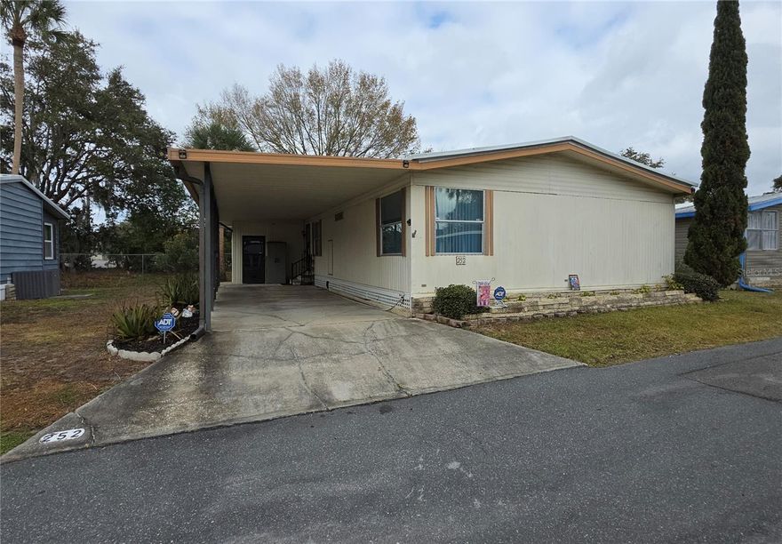 Discover comfort and easy living in this  2-bedroom, 2-bath home nestled in the sought-after 55+ waterfront community of Country Club Manor in Eustis, Florida — one of Lake County’s hidden treasures. This inviting residence features a dining area with a built-in china cabinet, a bright and functional kitchen, and a master suite includes a walk-in closet and step-in shower, while the second bedroom also offers a walk-in closet.. The spacious Florida room is perfect for enjoying morning coffee or evening breezes. The carport and storage shed provides a washer/dryer and extra storage. Major updates include a roof replacement in 2022, and HVAC in 2021 and newer laminate flooring.

Situated in charming, historic Eustis, you’ll be just minutes from boutique shopping, dining, medical facilities, and scenic Ferran Park on beautiful Lake Eustis. Enjoy the character of a small town paired with modern amenities, plus quick access to Mount Dora, Tavares, and the Harris Chain of Lakes.

Country Club Manor’s cooperative lifestyle offers exceptional value, with a monthly fee that includes water, sewer, trash, and access to amenities such as a private boat ramp to Trout Lake, heated pool, clubhouse, shuffleboard courts, and a lively calendar of community events and social activities.

Whether you're seeking a seasonal getaway or a year-round residence, this affordable opportunity delivers peaceful, active-adult living in a welcoming community. Schedule your private showing today and experience it for yourself