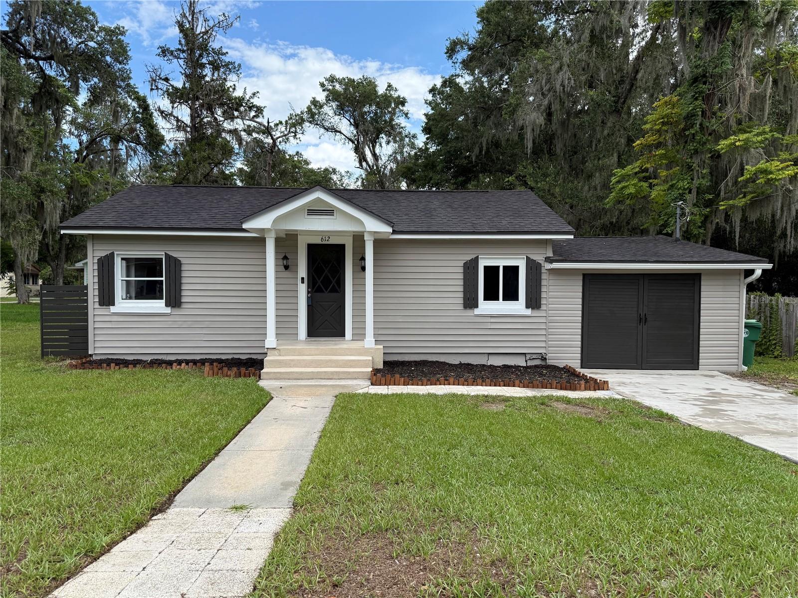 Welcome to Your Newly Renovated Turnkey Home in Historic DeLand!
Situated on a generous corner lot shaded by mature oak and palm trees, this beautifully renovated 2-bedroom, 2-bath home blends modern comfort with timeless charm across 1,125 square feet of thoughtfully updated living space.
Inside, brand-new wood-style luxury vinyl plank flooring stretches throughout the open-concept layout, creating a bright, airy feel. The heart of the home is the completely reimagined kitchen, featuring a center island, sleek modern cabinetry, and brand-new stainless steel appliances — ready for your culinary creations. Fresh neutral paint, crisp trim, and stylish new fixtures add a clean, modern aesthetic throughout.
The spacious living area opens through French doors to a private brick patio, ideal for morning coffee or evening wine under the stars. The beautiful wood-paneled ceiling and charming fireplace create a warm, inviting focal point in the living room, making the space feel truly special and full of character. Both bathrooms have been tastefully updated with contemporary vanities, tilework, and fixtures. Behind the scenes, all mechanical systems have been thoroughly inspected and refreshed — so you can move in with confidence.
What Makes This Home a Standout:
Fully renovated inside and out — just move in and enjoy.
Bright, open layout with great natural light and flow.
Brand-new concrete driveway and modern garage door elevate the home’s curb appeal.
Freshly installed gutters and paved side areas add function and finish to the spacious backyard.
Room to grow — perfect yard for a garden, outdoor entertaining, or future expansion.
Prime Location & Lifestyle
Enjoy the charm of DeLand with the comfort of modern living:
Only 5 minutes from Historic Downtown DeLand, filled with boutiques, coffee shops, galleries, and the iconic Athens Theatre.
Minutes from Stetson University, offering public cultural events, lectures, and the scenic Sandra Stetson Aquatic Center.
Surrounded by parks, nature trails, and wildlife preserves — a dream for outdoor enthusiasts.
Close to top-rated schools and shopping conveniences including Publix, Aldi, Walmart, and popular dining along Woodland Blvd.
The expanded SunRail/Amtrak station less than 5 minutes away in downtown DeLand — makes Orlando more accessible than ever and just a short train ride!
Perfect For:
Anyone who wants a move-in-ready home in a creative, connected, and community-focused neighborhood.
First-time buyers or downsizers seeking stylish, single-level living.
Investors looking for a high-quality rental or Airbnb in a thriving college-town.
Don’t miss your chance to own this freshly renovated gem in one of Central Florida’s most vibrant small cities.
Contact me today to schedule your private showing.