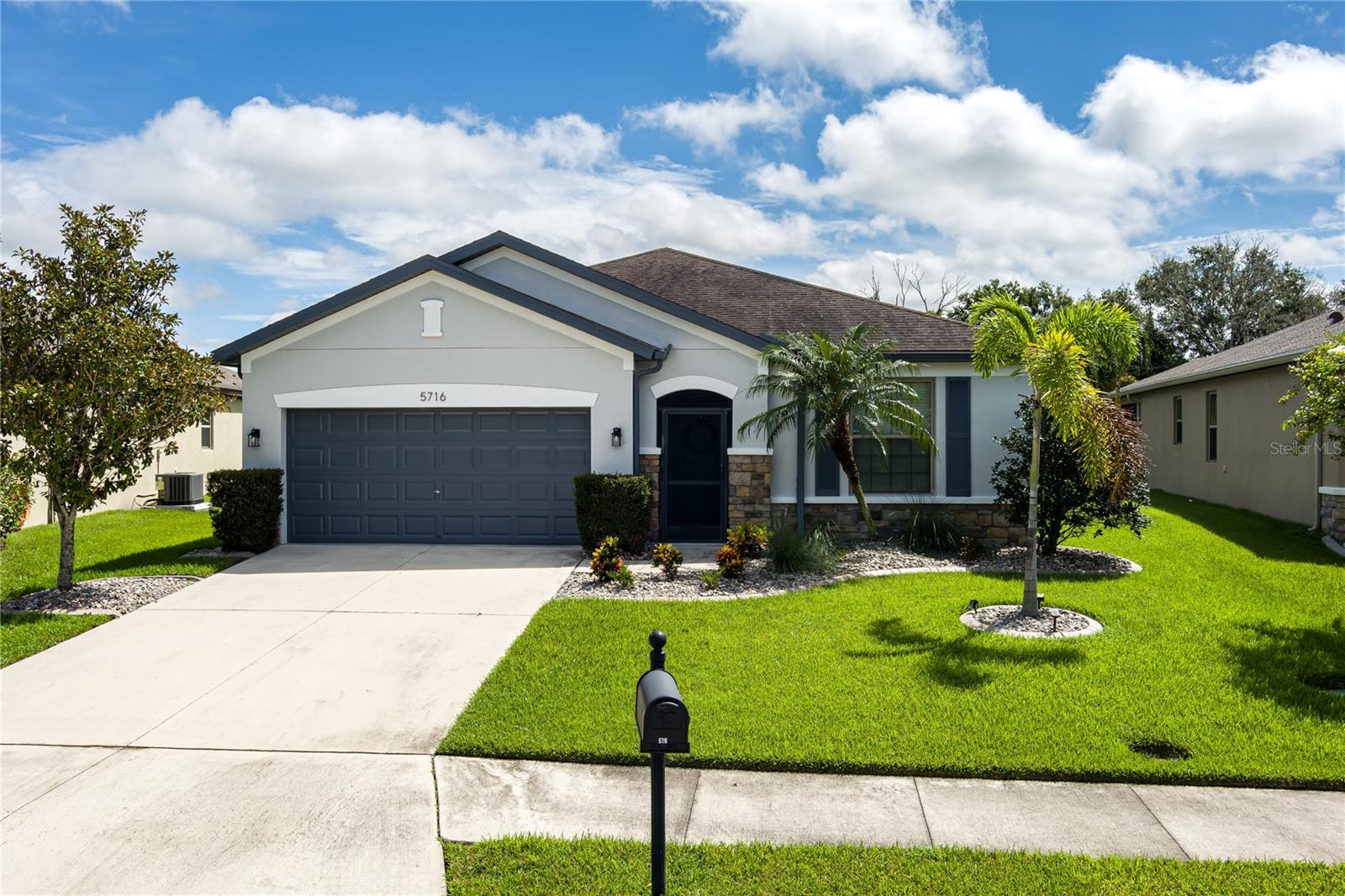 Presenting 5716 110th Avenue E, a well-appointed 2014-built single-family residence located in the desirable Harrison Ranch community, centrally positioned in Parrish, FL. Offering 2,144 square feet under air, this 3-bedroom, 2-bathroom, 2-car garage home features a newly painted exterior (2025) and meticulously maintained landscaping (added 2025), providing excellent curb appeal.
The interior layout includes a recently refreshed split floor plan (painted 2023), two spacious guest bedrooms with shared bath, a versatile den/office (suitable as a potential fourth bedroom), and a primary suite with an upgraded master bathroom (2024). The main living area is designed for flexibility and comfort, featuring an open-concept kitchen, dining, and living space. The kitchen is equipped with a large island, granite countertops, decorative backsplash, stainless steel appliances, and enhanced cabinetry. The living area offers an electric fireplace set against custom shiplap and provides access via a large slider to the covered lanai, open patio, and a fenced yard with water views.
Additional features include a built-in 'mud' area adjoining the indoor laundry and custom shelving in the garage. Community amenities comprise over five miles of walking trails, swimming pool, tennis courts, basketball and pickleball courts, park, playground, fitness center, clubhouse, and reclaimed water irrigation. Conveniently situated near acclaimed schools, dining, and shopping venues, this property delivers an optimal blend of comfort, accessibility, and quality living. Schedule your showing today!