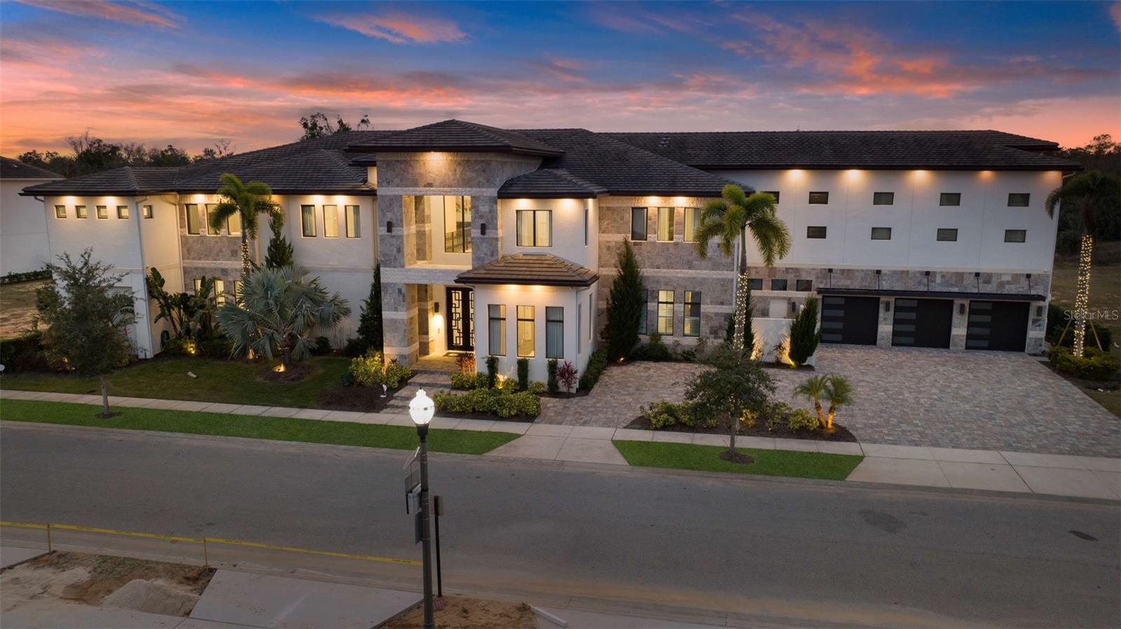 Welcome to 1148 Grand Traverse Pkwy, a stunning 21,397 sq. ft. estate that redefines the meaning of luxury living. This extraordinary 16-bedroom, 18-bathroom home comfortably accommodates up to 36 guests, making it the ultimate destination for family reunions, group retreats, milestone celebrations, or even your dream home for gatherings with family and friends. With its unparalleled amenities and contemporary design, this property is a premier vacation rental with a proven track record of success.
Upon entering this magnificent property, you are greeted by grand interiors with high-end finishes, expansive living spaces, and the ultimate resort living experience Florida has to offer. The chef’s kitchen is a culinary masterpiece, featuring top-of-the-line appliances, stunning stone countertops, a large island for preparing gourmet meals, and an impressive two commercial-sized refrigerators and freezers. The walk-in pantry and seating for 12 provide everything you need for entertaining in style. The adjacent dining area seats 20, creating the perfect setting for shared meals and unforgettable moments. Each of the 16 bedrooms serves as a private retreat, complete with luxurious finishes and spa-inspired en-suite bathrooms. The themed bedroom, inspired by Star Wars, is a showstopper, with a total of 12 bunks and a loft gaming area sure to captivate young adventurers.
1148 Grand Traverse Pkwy is an entertainer’s dream, offering an unmatched array of amenities for both relaxation and fun. The home features a dedicated spa room with a sauna, a state-of-the-art in-home gym for fitness enthusiasts, and a professional-grade golf simulator for those looking to perfect their swing. For sports lovers, there is a ½ court basketball court, while the arcade/game room will provide hours of entertainment with its 2-lane bowling alley, complete with bowling shoes in all sizes for a truly fun-filled experience. Movie lovers will delight in the private theater room, which seats 12 and offers the ultimate cinematic experience.
The outdoor living area is truly a highlight of this exceptional estate. The expansive back patio is equipped with a summer kitchen, perfect for preparing meals and dining al fresco. Numerous seating areas provide space for relaxation, while the hot tub, pool, water slide, and winding lazy river offer endless enjoyment. Whether you are lounging by the pool or enjoying a meal under the stars, the outdoor space at 1148 Grand Traverse Pkwy offers the perfect balance of luxury, leisure, and entertainment.
Reunion Resort is a luxurious vacation destination located near all that Central Florida is famous for and just a few miles from Walt Disney World. Along with 3 signature championship level golf courses designed by golf legends Jack Nicklaus, Tom Watson & Arnold Palmer, you'll enjoy a variety of restaurants from fine dining to more casual options along with poolside bars and coffee shops to start your day while never having to leave the resort. Additionally, there are multiple pools, onsite water park, kid's play areas, tennis, picklelball, fitness center & more.