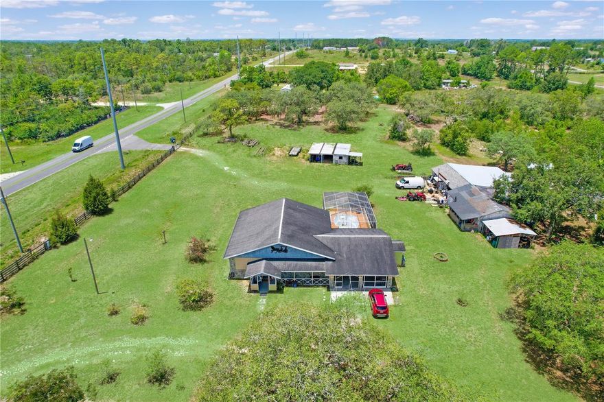 Opportunity meets potential on this slice of Florida countryside. 4.9 fully fenced acres at the corner of Hexam Rd and Sunshine Grove, this property offers the perfect blend of residential comfort, business potential, and recreational space. Zoned Agricultural, this property opens the door to a variety of farming or business ventures. Homesteading to horse boarding or nursery operations. It's prime location and frontage is currently zoned AG (Agricultural) and has a Future Land Use (FLU) designation of Rural, in accordance with the Hernando County Comprehensive Plan. Per the Comprehensive Plan, the Rural FLU designation allows for certain Neighborhood Commercial and Agricultural Commercial uses. AADT (Annual Average Daily Traffic) 14,500. Public water and sewer are available nearby. The home was custom-built by the owner, with 2 bedrooms, 2.5 bathrooms and was built to commercial code standards with electric wiring ran through steel conduit, 15-inch soundproof exterior walls, 12-foot high vaulted ceilings, and handcrafted Amish hickory cabinets. The open floor plan is perfect for entertaining, with a giant kitchen featuring an island for eating. Outside the cool epoxy deck has a deep private pool with an outdoor kitchen, a large screened-in lanai, and oversized ceiling fans, perfect for hosting family or clients. The property includes a horse barn, outdoor sinks, and fully fenced pasture with multiple gated entrances for easy access. The main workshop is fully powered and features a half bath, air lines, and plenty of shelving, ideal for running your business. Perfect set up for car enthusiasts, electricians, woodworking, powder coating, or storage. An additional building functions as an office, extra storage, or flex space. This is a rare opportunity for entrepreneurs or hobbyists to run their operations from home. The property has a second septic tank for RV hookup. Currently zoned AG this property is one of the last in the area that allows for a mini-farm, with the potential for future commercial zoning. Setback Grandfathered at only 75 ft from road center. Approved uses may include farm implement sales, agricultural supply, feed store, or even a place of worship. With Sandal Key being developed nearby, this is a rare opportunity to own 4.9 acres with no HOA, unmatched space, and future potential in a rapidly growing area. Located just minutes from Weeki Wachee Springs, US-19, SR-50, and the Veterans Expressway, you're close to Publix, restaurants, gyms, and beaches while still enjoying a peaceful rural setting. Everything you need is minutes away!! So much potential for this property! Call today for more details.