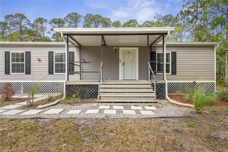 Dream Property Opportunity!! Welcome to peaceful country living on 2.28 cleared acres! Built less than 3 years ago, this move-in ready Colorado model by Live Oak Manufactured Homes offers 1,180 sq ft of thoughtfully designed living space with 3 bedrooms and 2 full baths. The property is mostly cleared with a 10-ft natural buffer around the perimeter, offering added privacy and a serene setting.

Step inside to a bright, open-concept layout featuring a modern kitchen that flows seamlessly into the living area, which is perfect for everyday living and entertaining. Enjoy the outdoors year-round with a spacious 15x20 screened-in rear deck that brings you right into nature, plus a charming 15x10 covered front porch ideal for morning coffee.

A standout feature is the detached 3-car metal garage with high ceilings, ideal for vehicles, storage, or a workshop, along with an RV hookup conveniently located behind the garage.

Major conveniences are already in place, including well water with double filtration and softener and a septic system positioned toward the rear of the property. Kitchen and laundry appliances (just 2 years old) are included, making this home truly move-in ready.

If you’re looking for space, privacy, and quiet living this is the one for you!