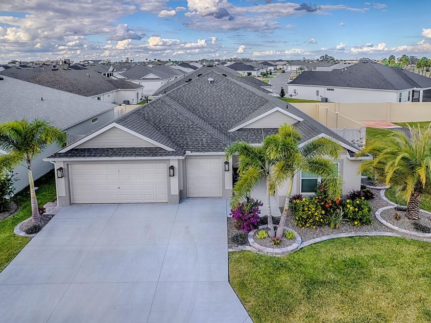 Location, Location, Location. This Mostly Turn Key Corner Lot home is a Beautiful "Monroe" Veranda home with a fully fenced backyard nestled in the desirable Village of Waters Edge near the new Eastport Town Square and the awesome Olympia recreation center. When Walking through the front door you see a spacious layout that includes a welcoming kitchen, dining room, and living room. The chef-style kitchen is a true highlight featuring soft close white cabinetry w/ pull outs, quartz countertops, stainless steel appliances, and a gas range-perfect for everyday meals or entertaining. Throughout the main living areas, luxury vinyl plank floors provide style and durability, while plush carpet in the bedrooms creates a cozy retreat. The primary suite offers comfort and elegance with two walk-in closets, dual vanities and a Roman walk-in shower. Two additional guest rooms share a full bath with a convenient pocket door for added privacy. Outside is a private lanai and backyard oasis, perfect for relaxing. Storage is no problem with the 2-car plus golf car garage all beautifully done in non slip epoxy floors. This home is ideally located minutes from Eastport, Middleton, Magnolia Plaza and Sawgrass Grove, giving you quick access to grocery stores, restaurants, an indoor food court, and nightly live entertainment-as well as pools, golf, pickleball, bike trails, and walking paths. Come enjoy your very own Florida paradise in The Villages. A quick close is available and seller is motivated.