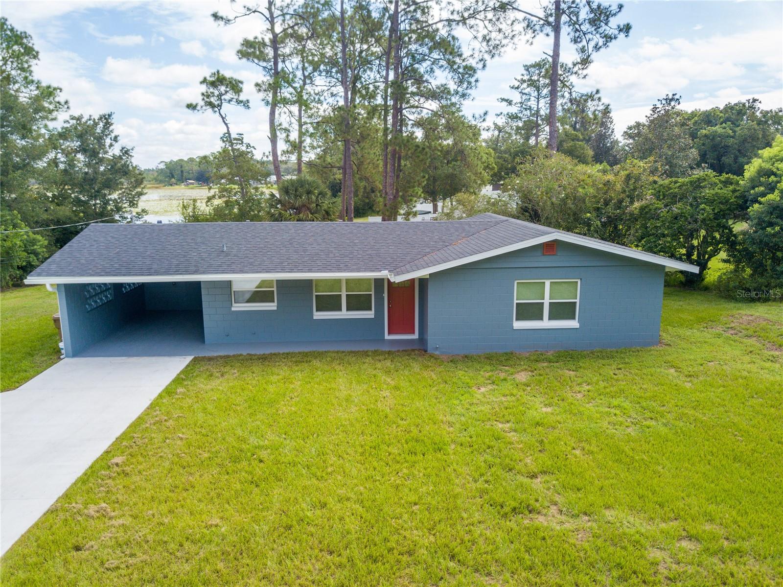 Discover this fully renovated 2 bedroom, 2 bath lakefront home located directly on Lake Bracy in Umatilla. Nearly every feature of this property has been updated, giving you peace of mind and modern comfort in a beautiful waterfront setting. Renovations include a brand-new roof, windows, exterior doors, cement fiberboard siding on the gables, aluminum soffit and fascia, exterior paint, and a concrete driveway. Inside, you’ll find new luxury vinyl plank flooring, quartz countertops, premium white shaker cabinets, stainless steel appliances, recessed lighting, light fixtures, interior doors and trim, plumbing fixtures, toilets, mirrors, and shelving. The home also features a new air conditioning system, a new water heater, new blown-in insulation, a new electrical panel, and new PEX plumbing throughout. A new water treatment system with a softener has also been installed. The laundry room is complete with its own cabinet and countertop package for added convenience. Enjoy lakefront living with your own water access and stunning views, all without HOA restrictions for ultimate freedom. Located in the county, which means a lower tax bill! This move-in-ready home offers the perfect blend of modern updates and a peaceful waterfront lifestyle.