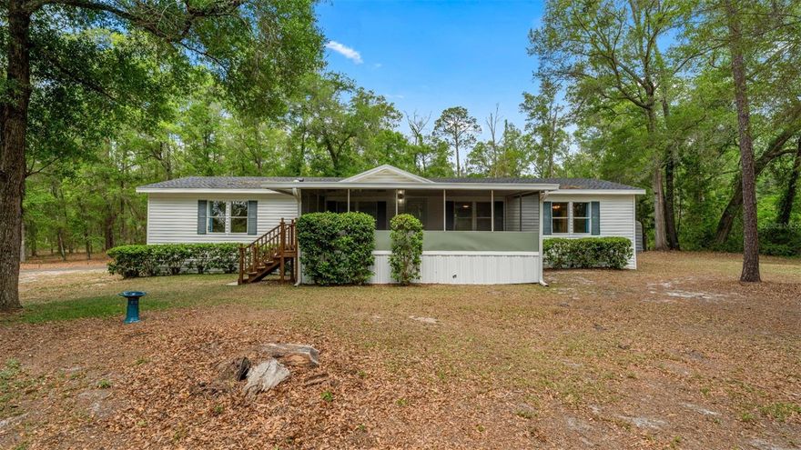 Welcome to this well-maintained double-wide manufactured home nestled on a nearly one-acre corner lot in the peaceful University Country Estates community of Archer, Florida. This move-in ready 3-bedroom, 3-bathroom home offers 1,488 square feet of comfortable living space with privacy, nature, and convenience all in one package.
Step inside to find a bright, open layout with laminate flooring throughout, a spacious living and dining area, and a kitchen equipped with a dishwasher, range, and range hood. Each of the three bedrooms features built-in closets, and the home is serviced by central heat and air with a recently maintained HVAC system keeping you comfortable year-round. Laundry hookups are already in place for your washer and dryer.
Outside, the property truly shines. Brand new front and back exterior doors welcome you home, while the lot with its rear fenced in area offers privacy and security for family, pets, and peace of mind. Enjoy your mornings on the front porch or unwind on the screened rear porch surrounded by nature. The forested portion of the property has been thoughtfully cleared of underbrush, giving you a clean, park-like setting that's ready to enjoy without the maintenance headache. Rain gutters and a shingle roof round out the exterior.
With a private well, septic system, and no HOA fees, your monthly costs stay low. Located with easy access to paved roads and just a short drive to Gainesville, this property offers the best of rural Florida living without sacrificing convenience.
Don't miss this rare opportunity and schedule your showing today!