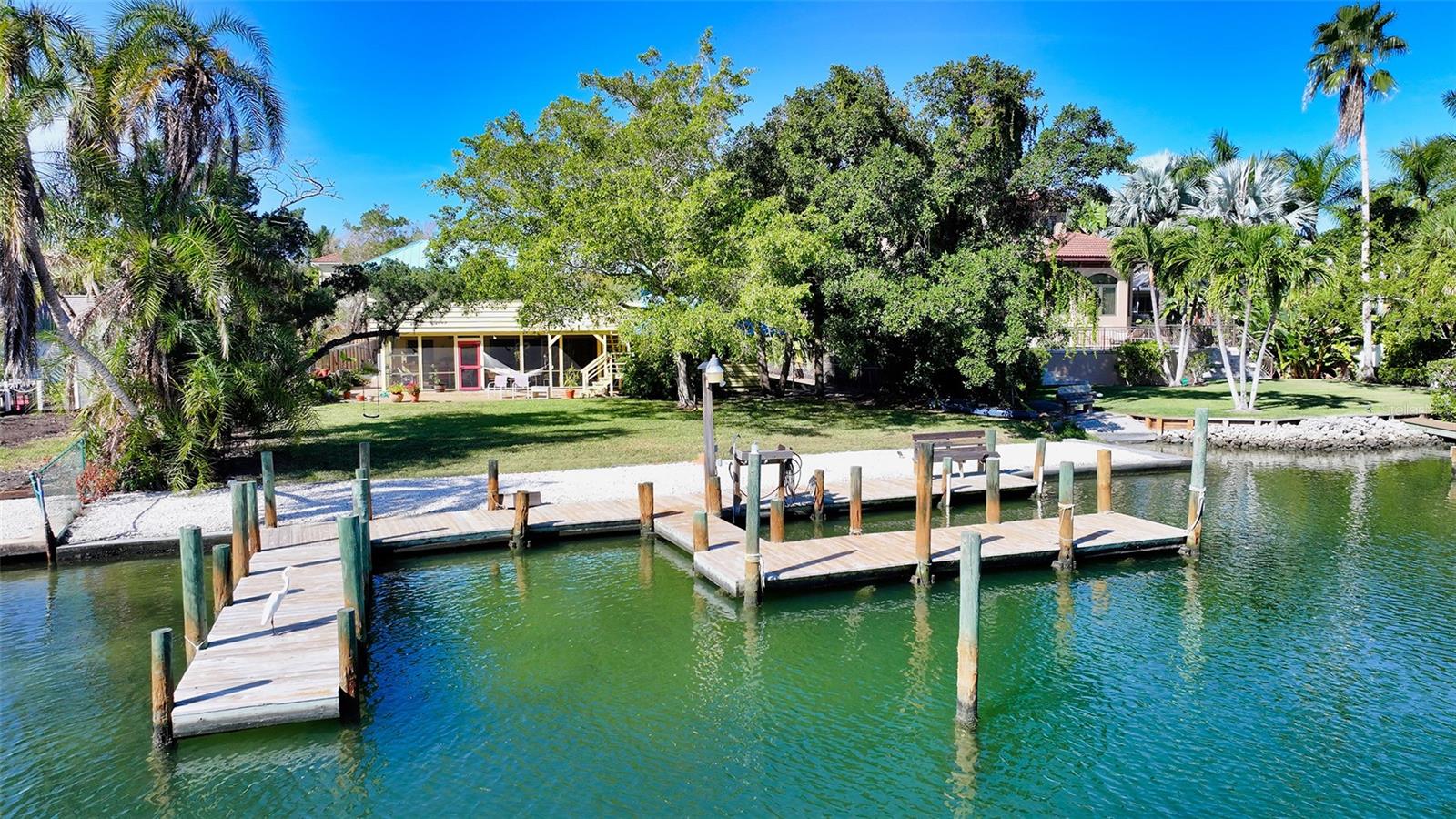 Sailboat Waterfront Property on Siesta Key!! This hidden gem of a sailboat waterfront property on Siesta Key's north end is a boater's paradise, with its expansive 18,367 square-foot lot and over 78 feet of seawall providing unrestricted access to the tranquil waters of Hansen Bayou and Sarasota Bay beyond. Nestled in privacy, it's an ideal location to build your dream home, offering captivating views and the serenity of this unique Siesta Key enclave. Its proximity to Shell Beach public access, as well as Siesta Village and renowned beach Siesta Key Beach along with easy access to shopping, restaurants, excellent schools, the hospital, and the vibrant downtown district of Sarasota, make it a convenient yet secluded retreat for those seeking the quintessential Florida waterfront lifestyle.
